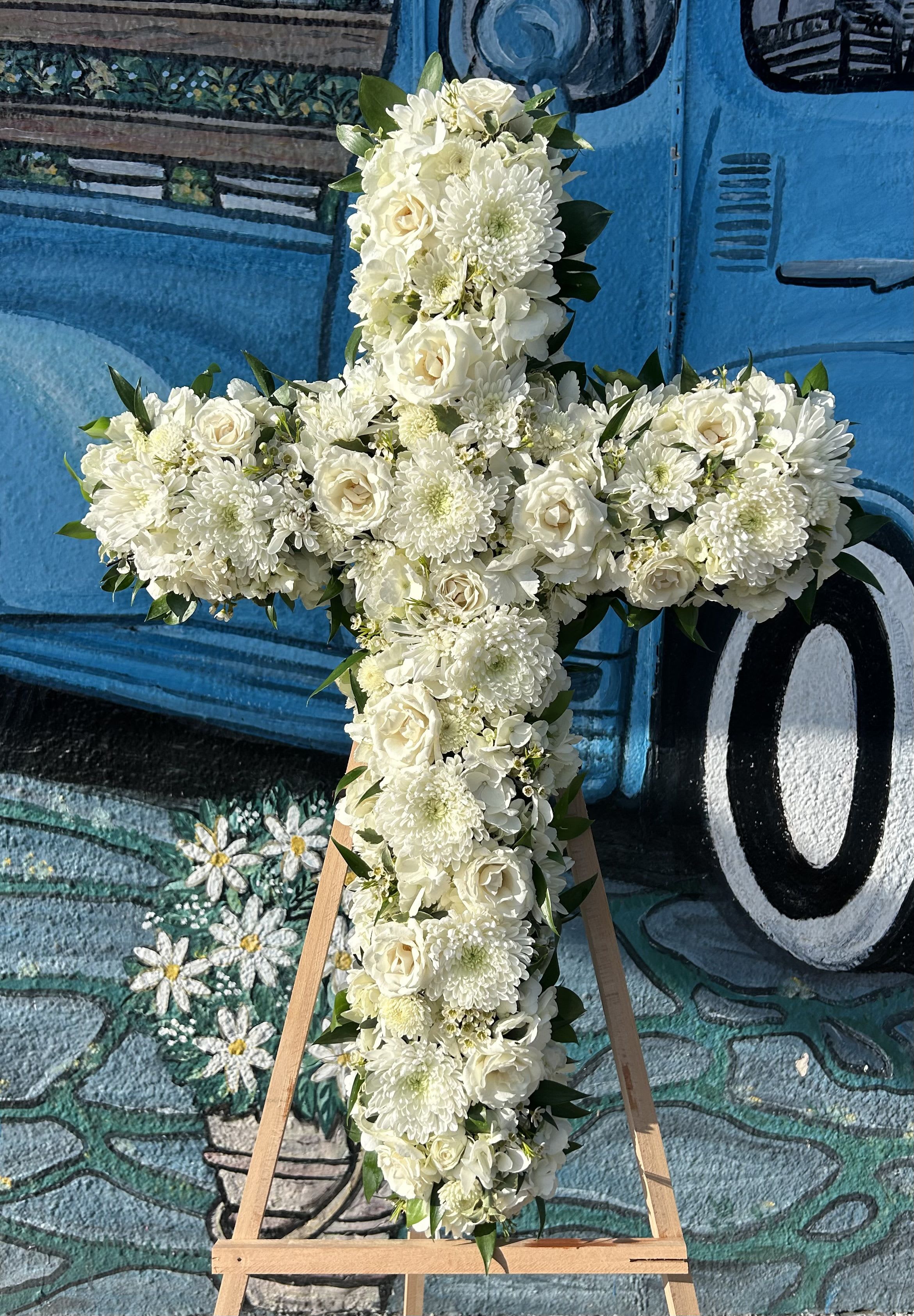 White Mix Cross - Seasonal white flowers arranged into a cross spray. 