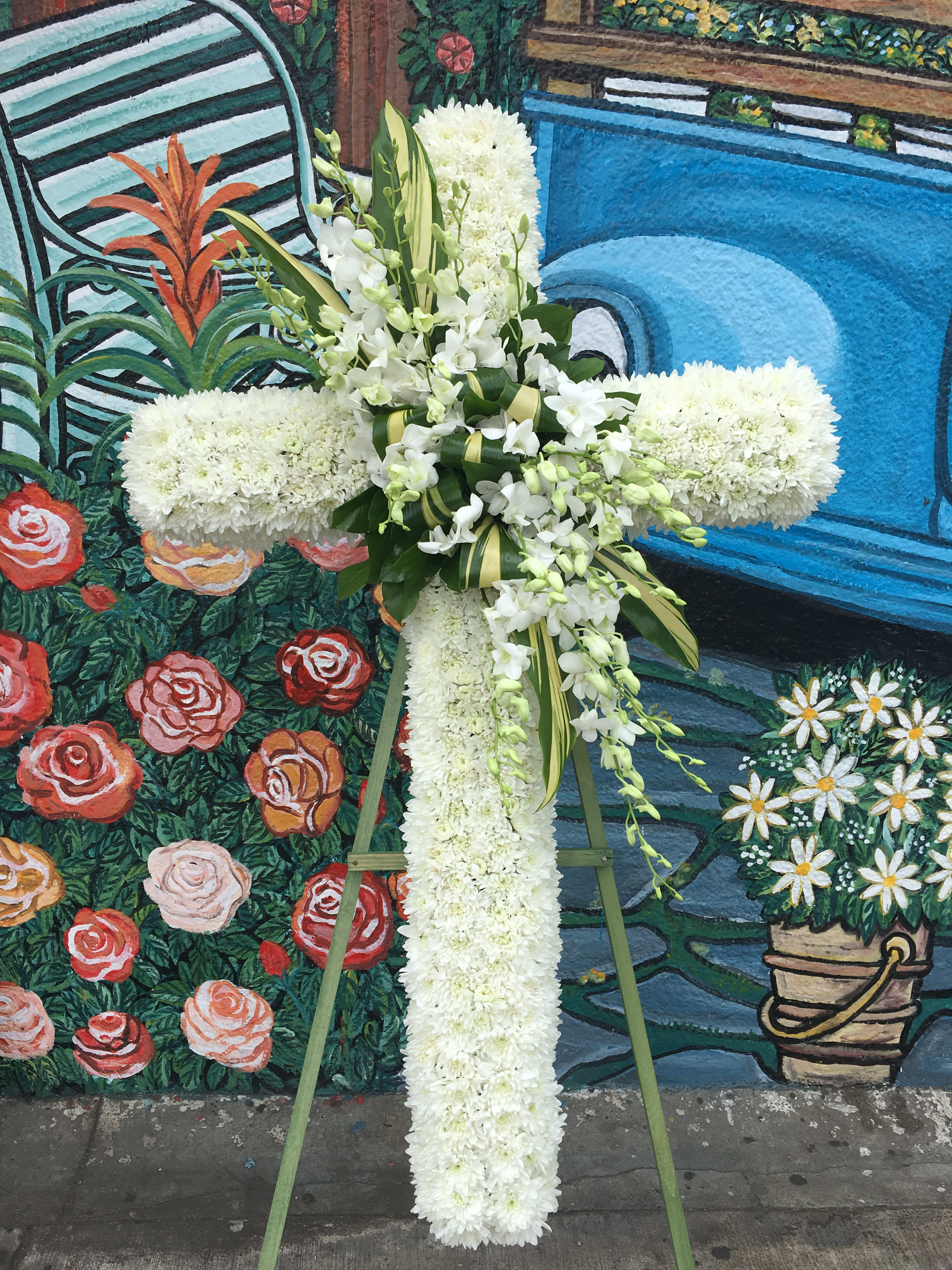 Peaceful Resting  - Seasonal white flowers arranged into a cross. (Wood stand included)  *(Order must be placed at least 2-3 days, same day pick-up or delivery is not available)*) 