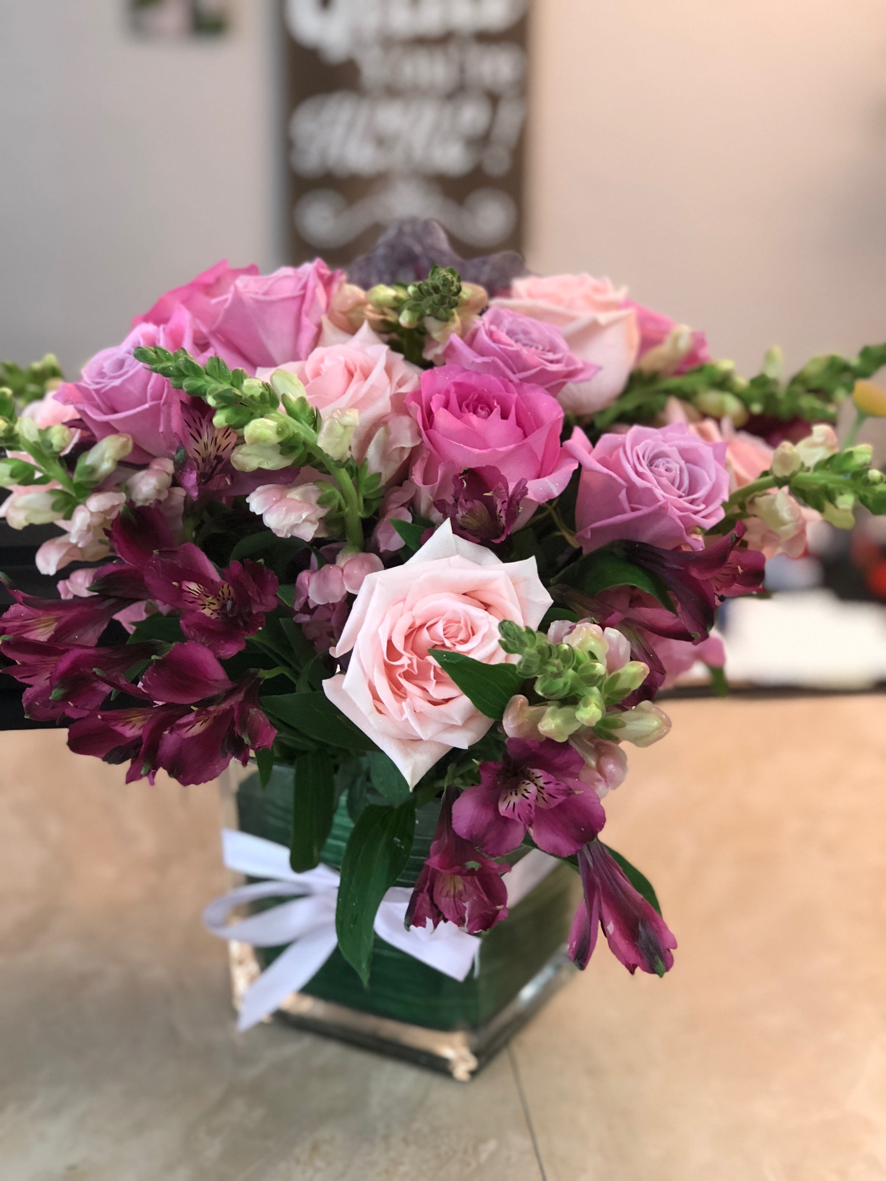 Pink Magic - Assorted Pink blooms in a tai leaf wrapped vase