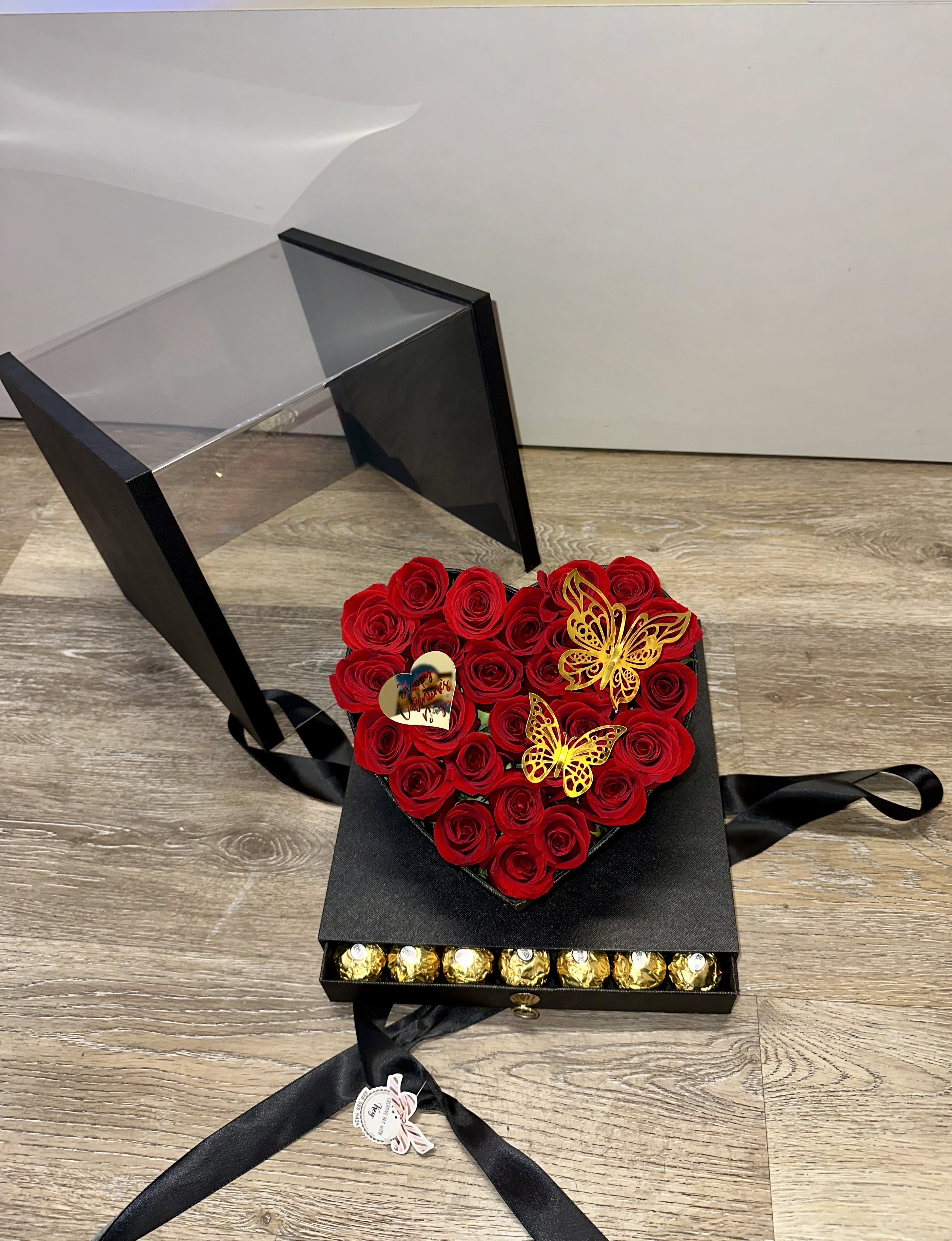   box with natural  roses, 48 ​​Ferrero Rocher chocolates in the bottom drawer, decorative butterfly, and acrylic Valentine's Day topper. - Beautiful acrylic box with natural red roses, 48 ​​Ferrero Rocher chocolates in the bottom drawer, decorative butterfly, and acrylic Valentine's Day topper.