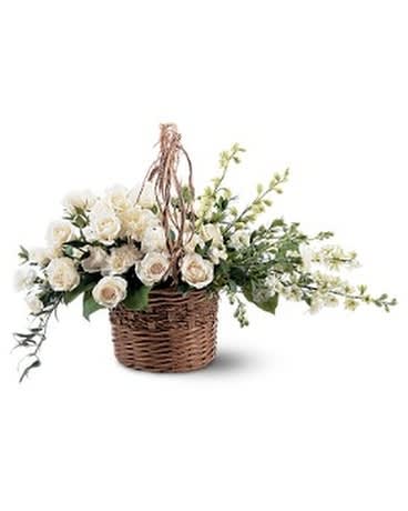 BASKET OF LIGHT - This delicate wicker basket filled with beautiful white flowers will surely spread some light to those you're thinking of. Perfect for the service or the home. One small wicker basket with handle arrives filled with white carnations, larkspur and roses.  Approximately 27" W x 14" H