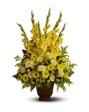 SUNNY MEMORIES - Honor a bright spirit who was like a ray of sunshine to everyone they encountered, with a grand display of bold yellow blossoms. At almost three feet tall, it will add a touch of brightness to any tribute. A mix of fresh yellow flowers such as roses, gladioli and chrysanthemums – accented with fern – is delivered in a Teleflora Noble Heritage urn.  Approximately 19" (W) x 35" (H)  
