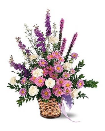 LAVENDER REMINDER BASKET - This lovely lavender arrangement, with its asters, chrysanthemums and larkspur, will remind us all that there's hope. One arrangement with lavender asters, chrysanthemums and larkspur, and white carnations and spray asters is delivered in a natural wicker basket.  Approximately 29" W x 32" H