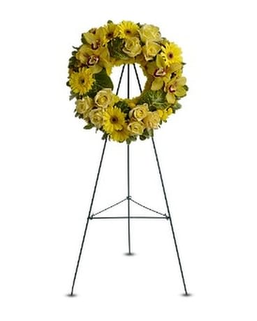 CIRCLE OF SUNSHINE Wreath - This sunny yellow wreath of blooms including roses, Cymbidium orchids and chrysanthemums will bring golden memories of a much-loved spirit to a wake, memorial or funeral service. A standing wreath of fresh flowers such as roses, Cymbidium orchids, gerberas and chrysanthemums – in shades of yellow and bronze – is delivered on an easel.