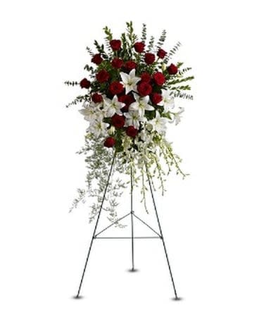 LILY AND ROSE TRIBUTE SPRAY - Pure white lilies and Dendrobium orchids mingle with red roses, white Asiatic lilies and more in this magnificent and impressive standing spray of the finest blooms. A fitting tribute for a funeral, wake or memorial service. A standing spray of red roses, white Dendrobium orchids and Asiatic lilies – accented with greenery – is delivered on an easel.  Approximately 22" (W) x 36" (H) (Dimensions do not include easel.)