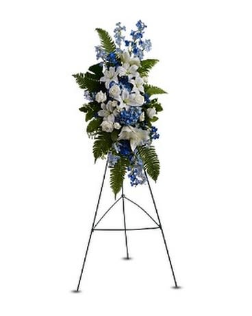 OCEAN BREEZE SPRAY - Like a refreshing ocean breeze, this cool-hued standing spray of white and blue flowers including roses, Asiatic lilies and delphinium, will bring a sense of peace and calm to any service or memorial. A standing spray of fresh blue and white flowers such as Asiatic lilies, roses, delphinium and hydrangea – accented with ferns – is delivered on an easel.  Approximately 19" (W) x 22" (H) (Dimensions do not include easel.)