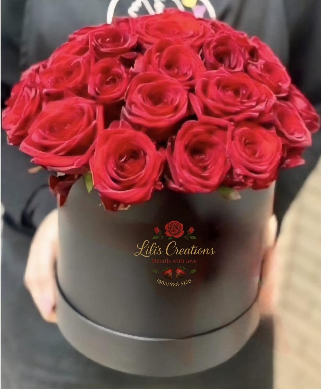RACHY - A beautiful black box filled with red roses, adorned with a lovely ribbon. Ready to melt the heart of your loved one.