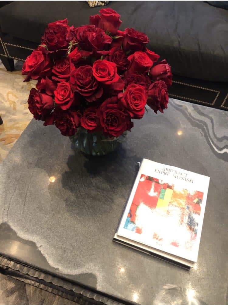 "Rudolph Valentino" roses arrangement - 4 dozen roses in a large pave style. Glass container. Pictured in red. Other color options possible, based on availability.