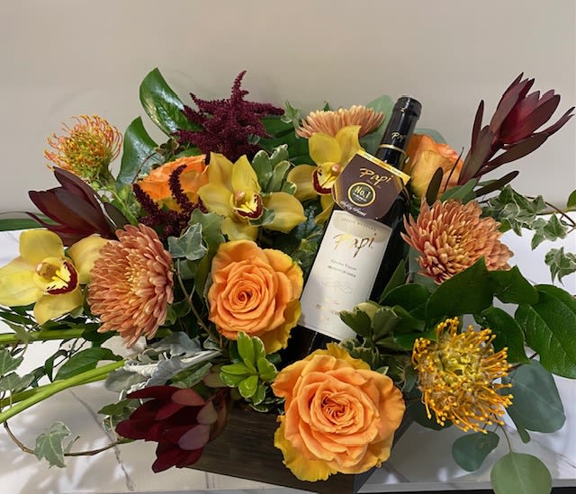 Mami Loves "Papi" Garden Box  -  This exquisite arrangement features autumn-colored blooms elegantly displayed in a charming garden box. Accompanied by a bottle of "Papi" Pinot Noir, it’s a perfect high-end gift to celebrate love and appreciation for any special occasion.