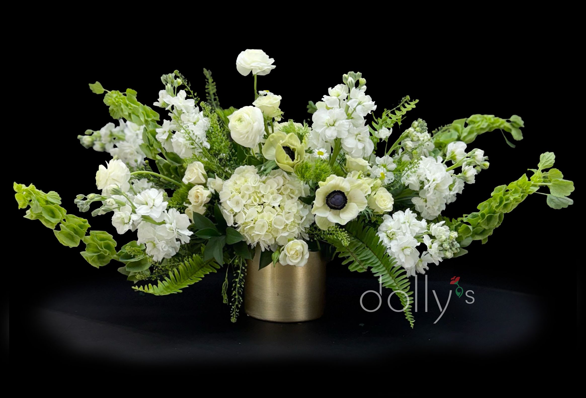 Centerpiece | Panda | Gold - A beautiful and long centerpiece comprised of ranunculus, bells of Ireland, anemone, hydrangeas, roses, lepidium, and monte casino aster.  Approx 36" (91.44cm) long.