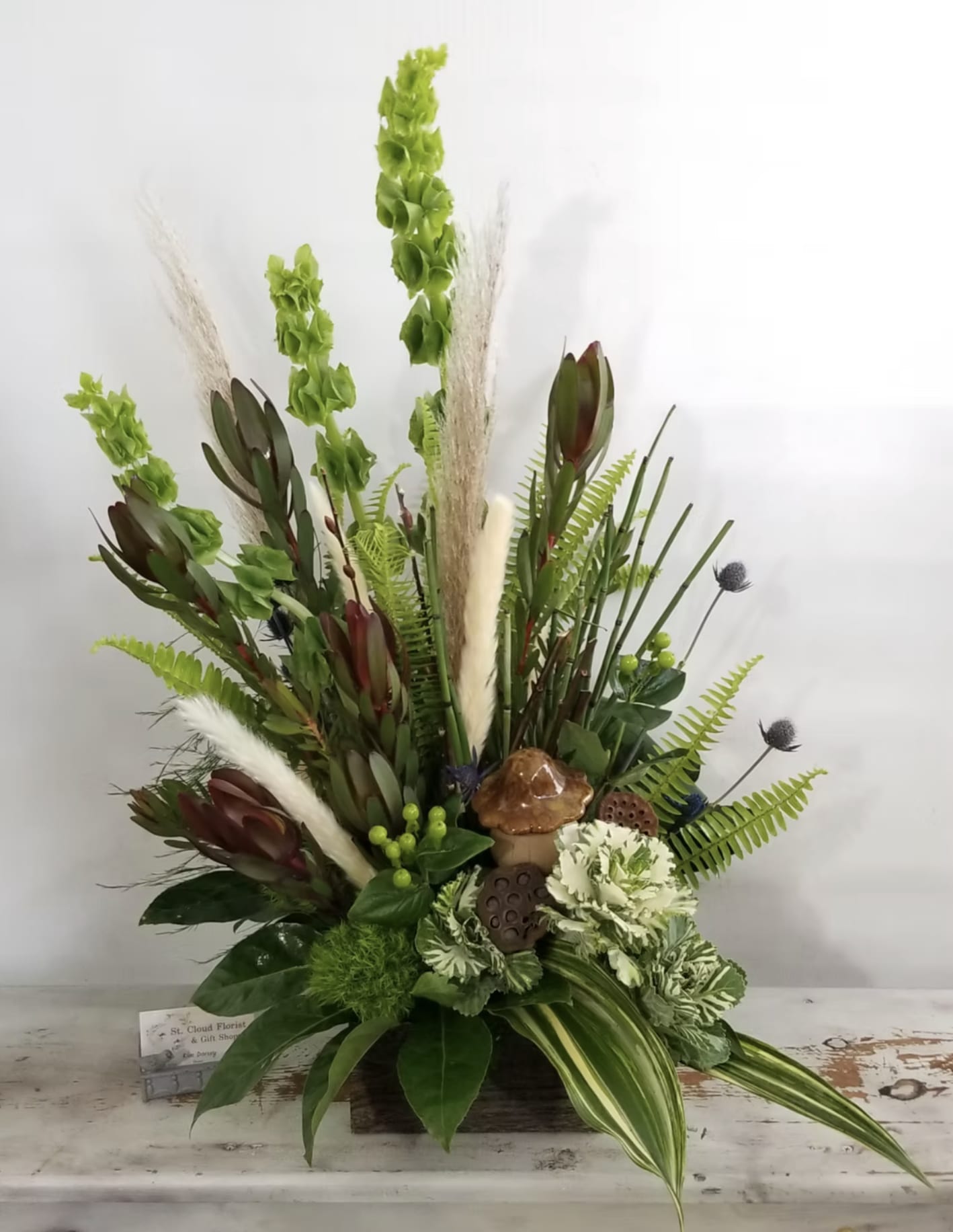 Custom Woodsy Arrangement - Flowers, containers and gift items are subject to substitution and availability. 