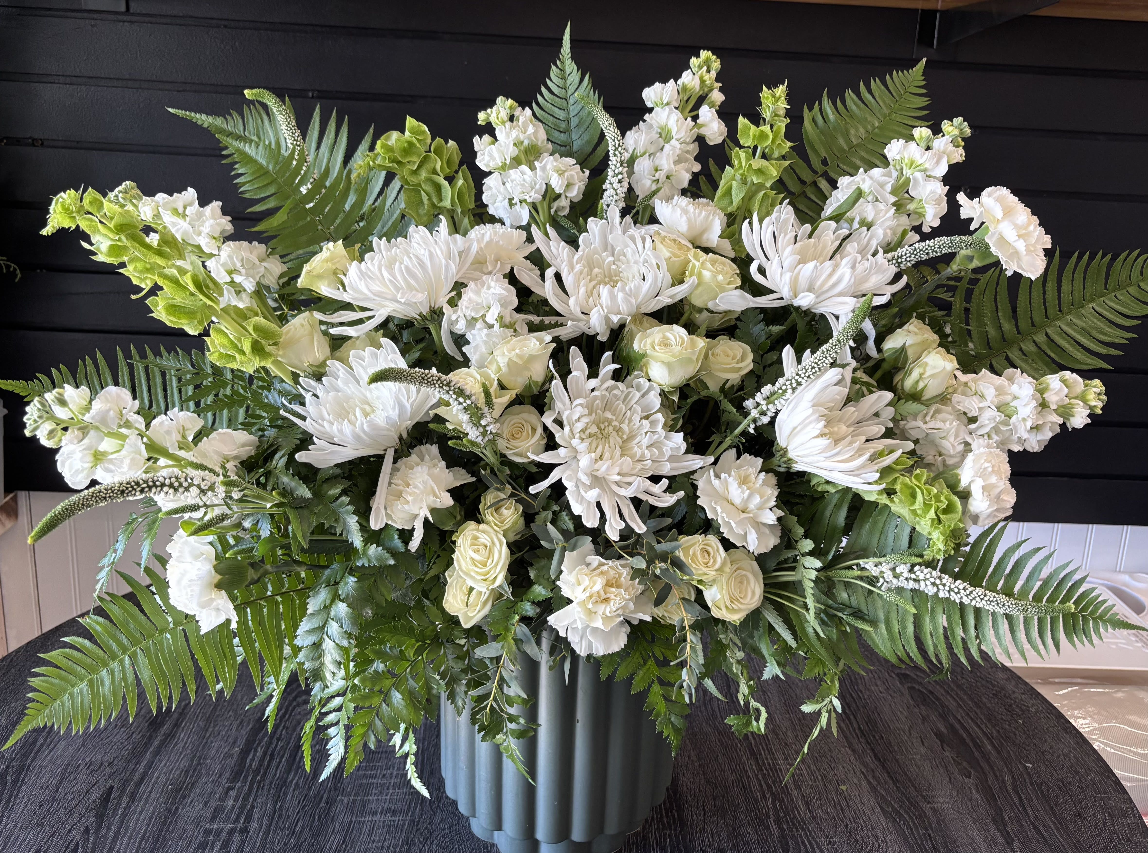 Elegant Sympathy Bouquet - Mixed greenery with ivory florals in a contemporary green pot. Classic and elegant. 