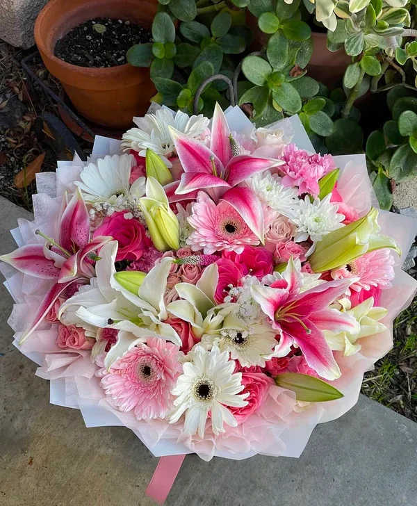 Lily Fantasy (bouquet) - A bouquet filled with lilies gerbera Dasie and more beautiful blooms with a beautiful silk tissue and a unique wrap around it. 