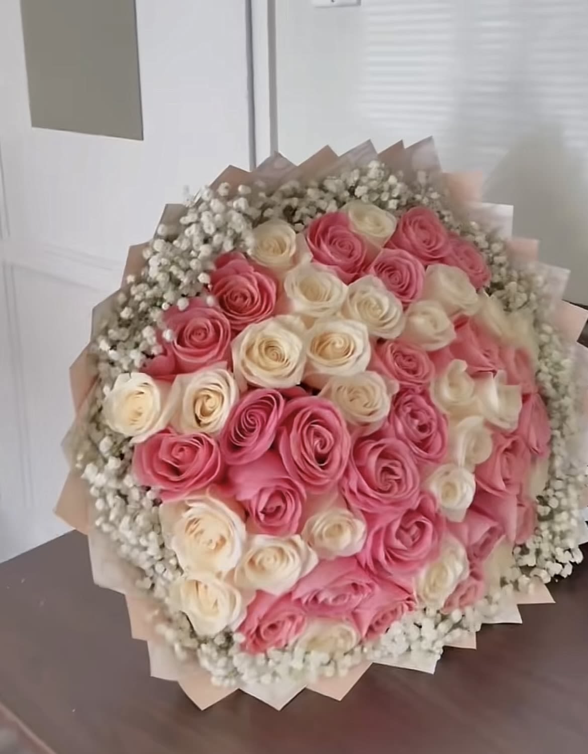 The hermosa bouquet - This bouquet includes 50 long stem roses and a rim of baby breath around the bouquet