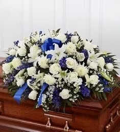 My Sweet Angel (casket funeral ) - Half casket arrangement with white and blue shades with a beautiful bow fully personalized for you and your family.