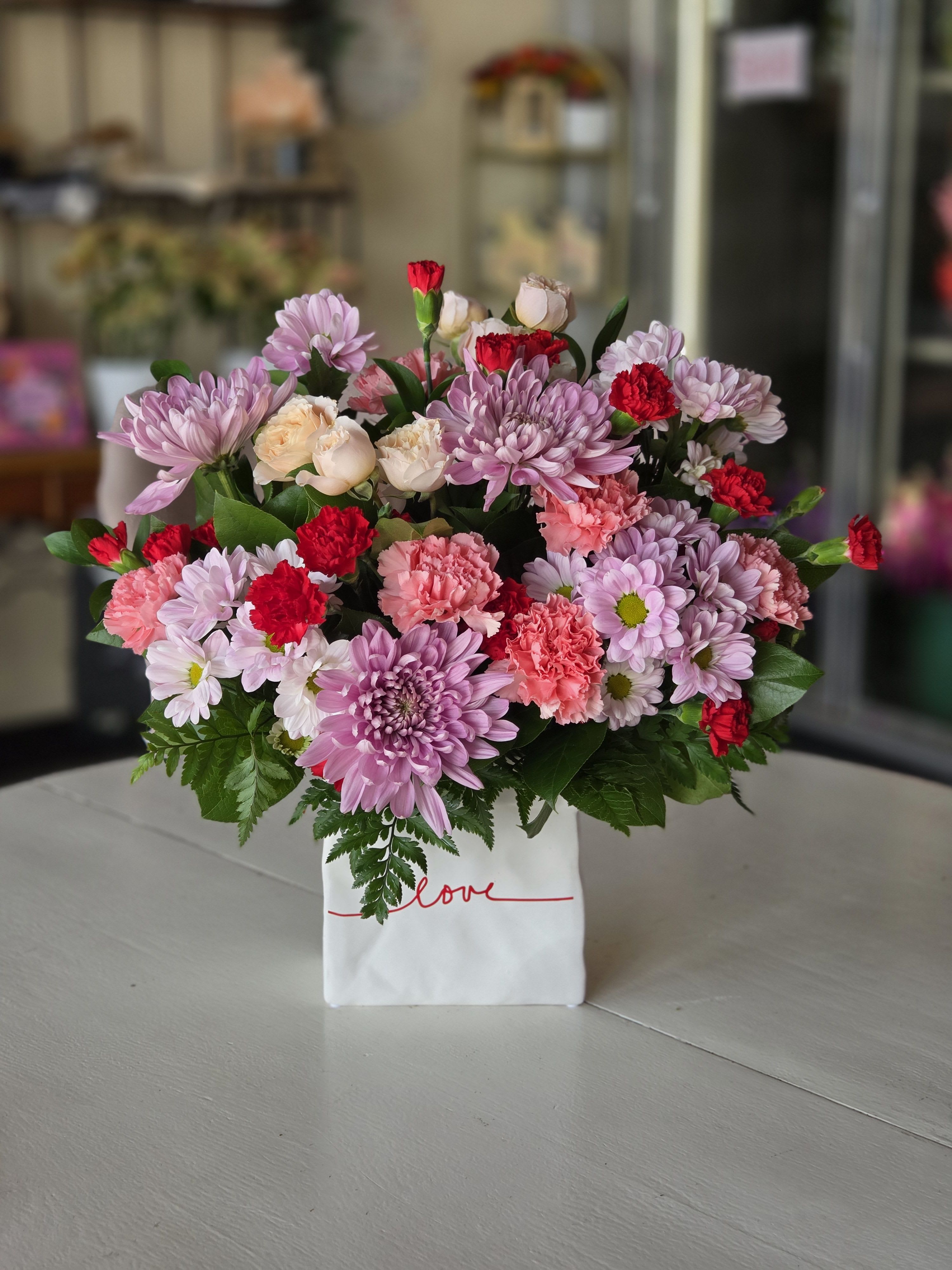 Love Note - A sweet and colorful bouquet bursting with soft petals and love-filled charm.