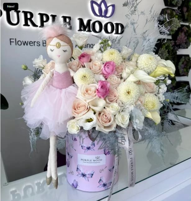 Welcome Princess Box - Container size - D8.25'x H9.5'  Welcome Princess Box Celebrate the arrival of a precious baby girl with the Welcome Princess Box. Designed in soft pastel tones and presented in a delicate butterfly-patterned box, this arrangement captures sweetness and grace. Complete with an adorable ballerina doll, it’s the perfect way to welcome a new little princess into the world.      •    Elegant mix of soft blush, cream, and pastel shades     •    Presented in a signature butterfly-print box     •    Includes a charming ballerina doll keepsake     •    A thoughtful gift for baby showers, hospital visits, or home celebrations