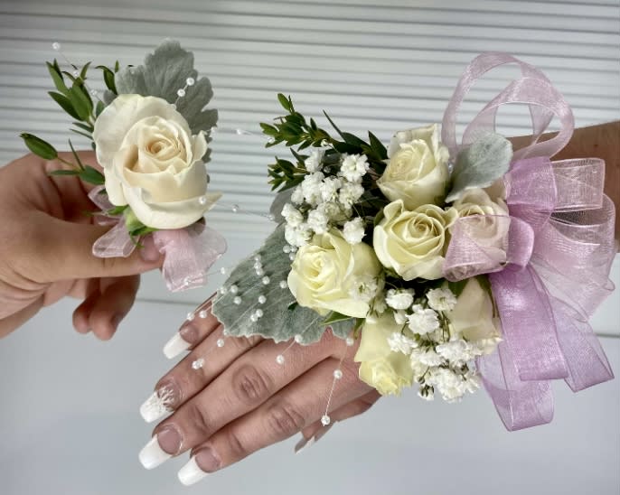 White and pink corsage &amp; Boutonnière  - White spray roses and light pink ribbons.