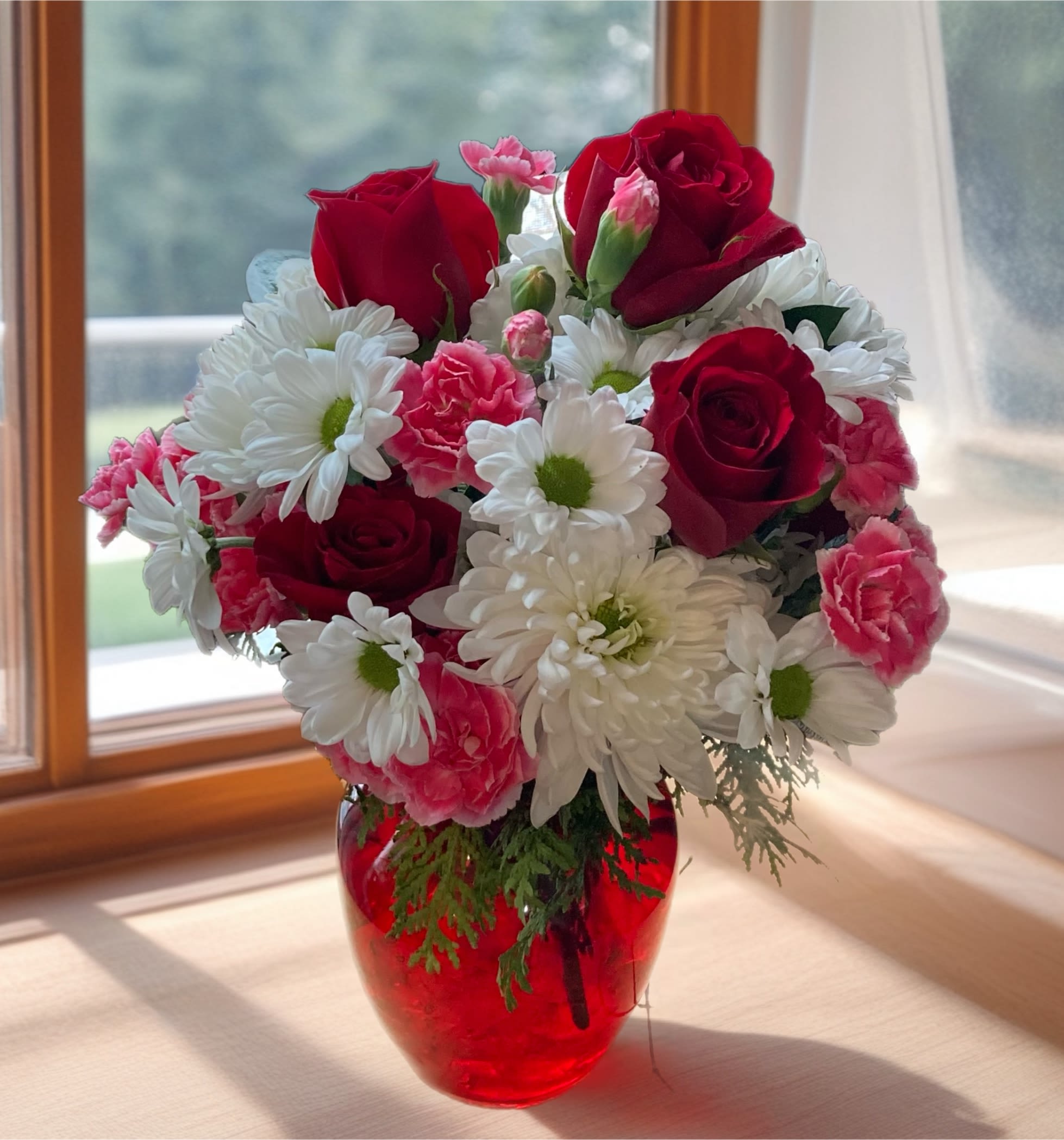 Sweet Red. A Floral Archist™ Design.  - This bouquet is a sweet way to show someone you care. It is a great gift for Birthdays, thinking of you , Valentine’s or an any day gift.  NOTE: Our flowers and greens are a gift from nature. It’s shade and depth might vary, design, aesthetic and value remains the same. In support of our efforts to aide in the preservation of our planet, PJf uses Fair Trade flowers, Plants, Upcycled or Recycled containers. Vase may vary.