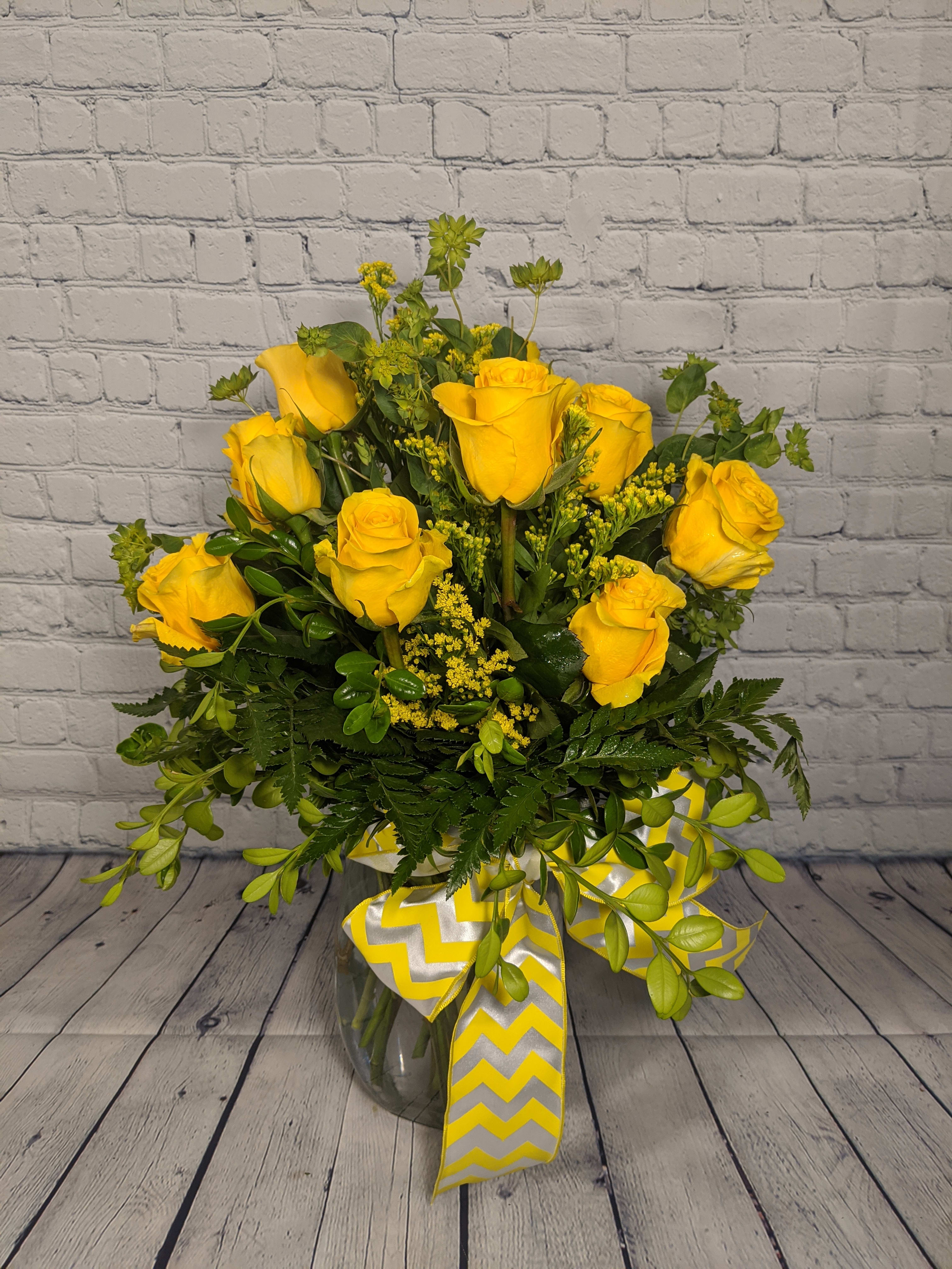 Dozen Long Stemmed Yellow Roses - This all around arrangement is the perfect "pick me up" to brighten someone's day. One dozen long stemmed yellow roses are the perfect gift for a birthday, get well, just because, or as a thank you.  