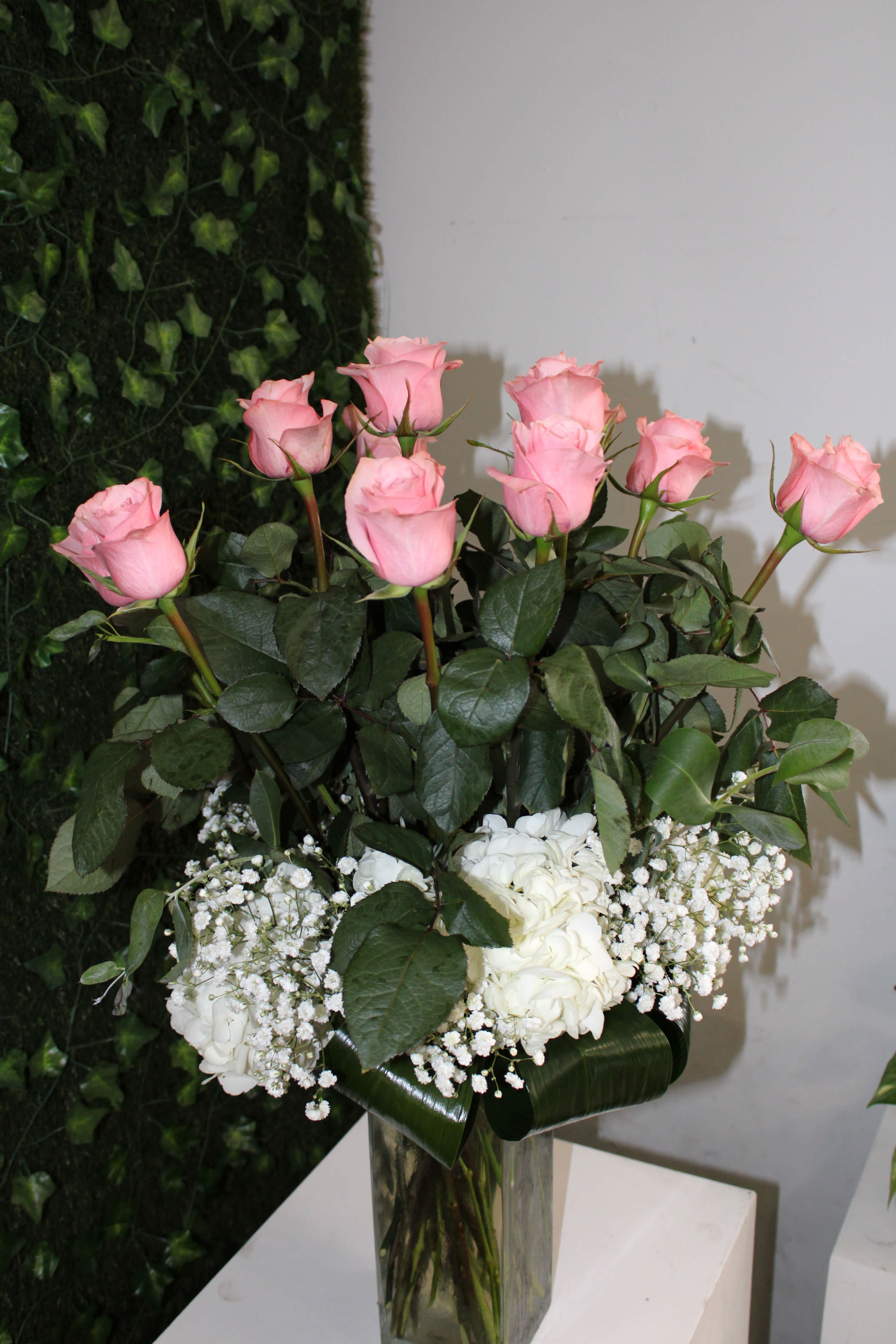 Rosy Roses - 12 long stem light pink roses, white hydrangeas and white babies breathe in a glass vase. 