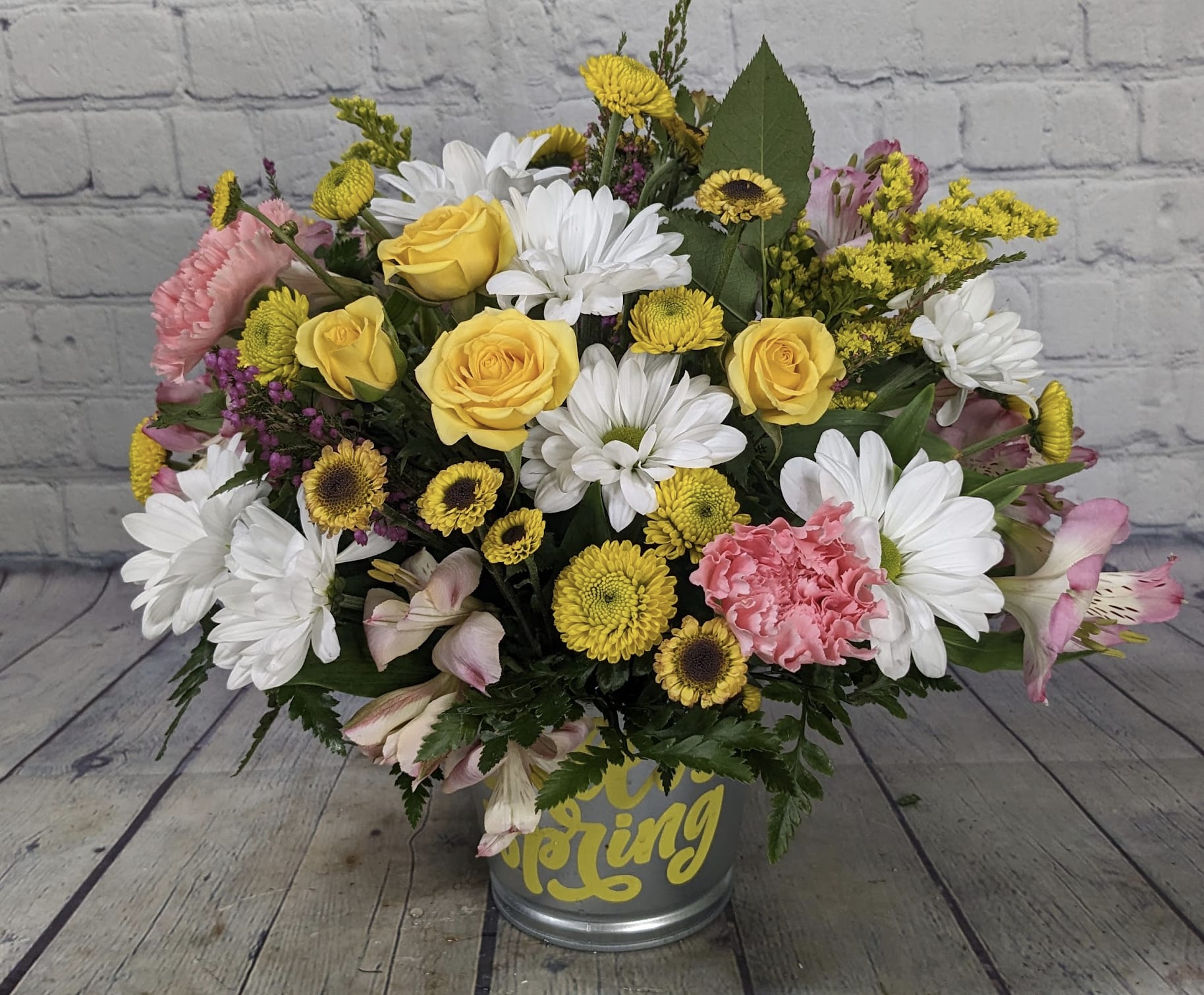 Hello Spring - Say hello to spring with this bright and cheerful bouquet bursting with seasonal color. White daisies, pink carnations, sunny yellow spray roses, yellow button mums, alstroemeria, and solidago come together to celebrate longer days and warmer moments. It’s the perfect way to say goodbye to winter and welcome spring with open arms.