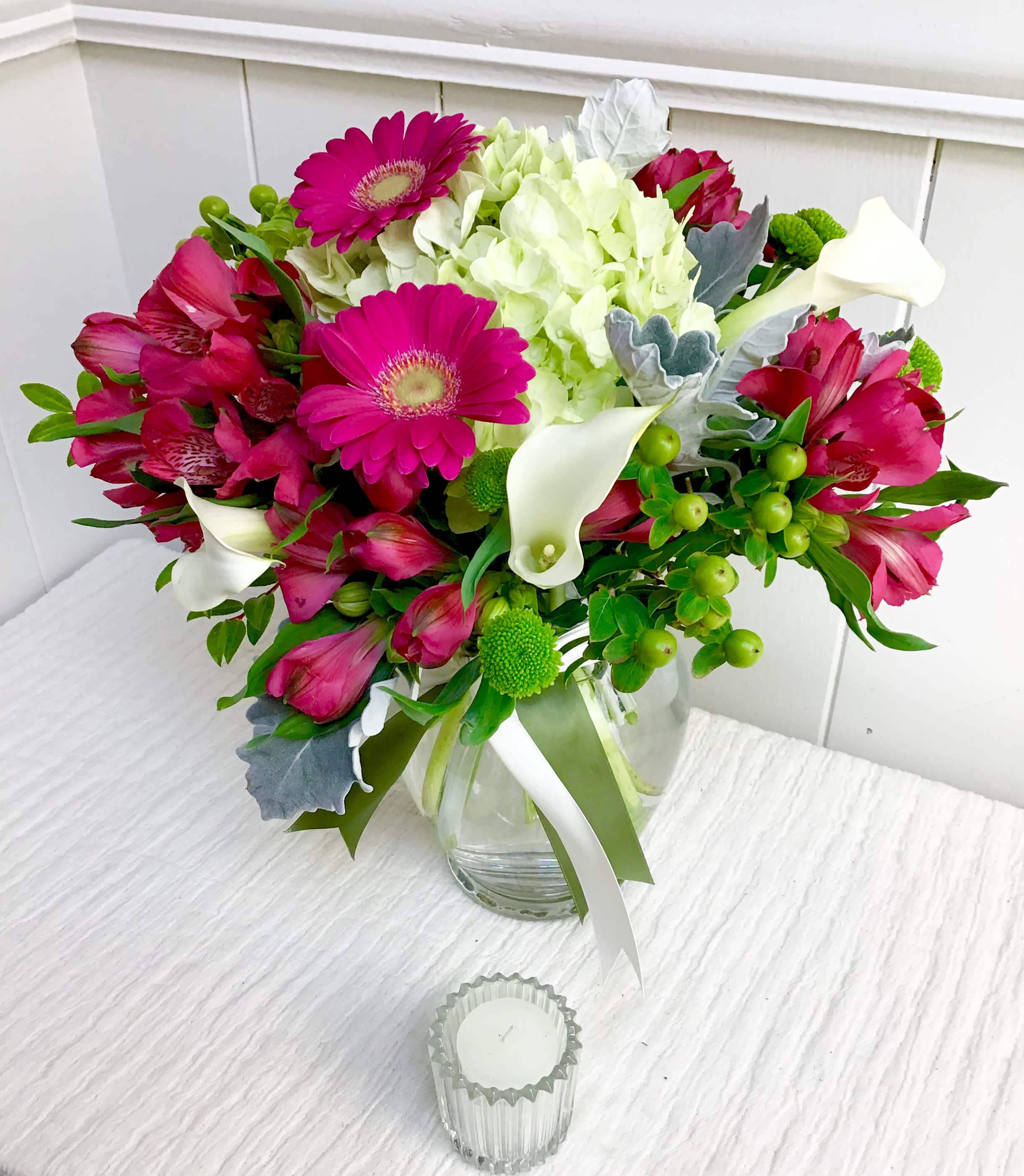 All About That Beauty - This tall clear glass vase is overflowing with a beautiful mix of fresh white cala lilies, chartreuse hydrangea and pink gerbera daisies.