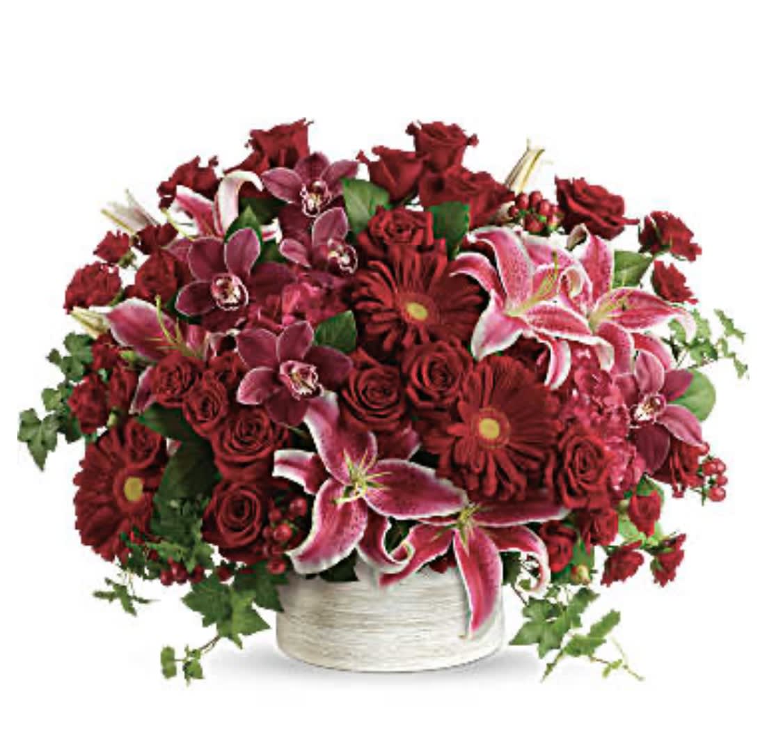 Stunning Statement Bouquet - What a stunner! Leave them speechless with this boldly blooming statement of red hydrangea, orchids and roses, overflowing from a modern white cylinder. This stunning arrangement of red hydrangea, red cymbidium orchid blossoms, red roses, red spray roses, hot pink oriental lilies, red gerberas, and red hypericum is accented with green ivy and lemon leaf. Delivered in a white cylinder planter. Orientation: All-Around