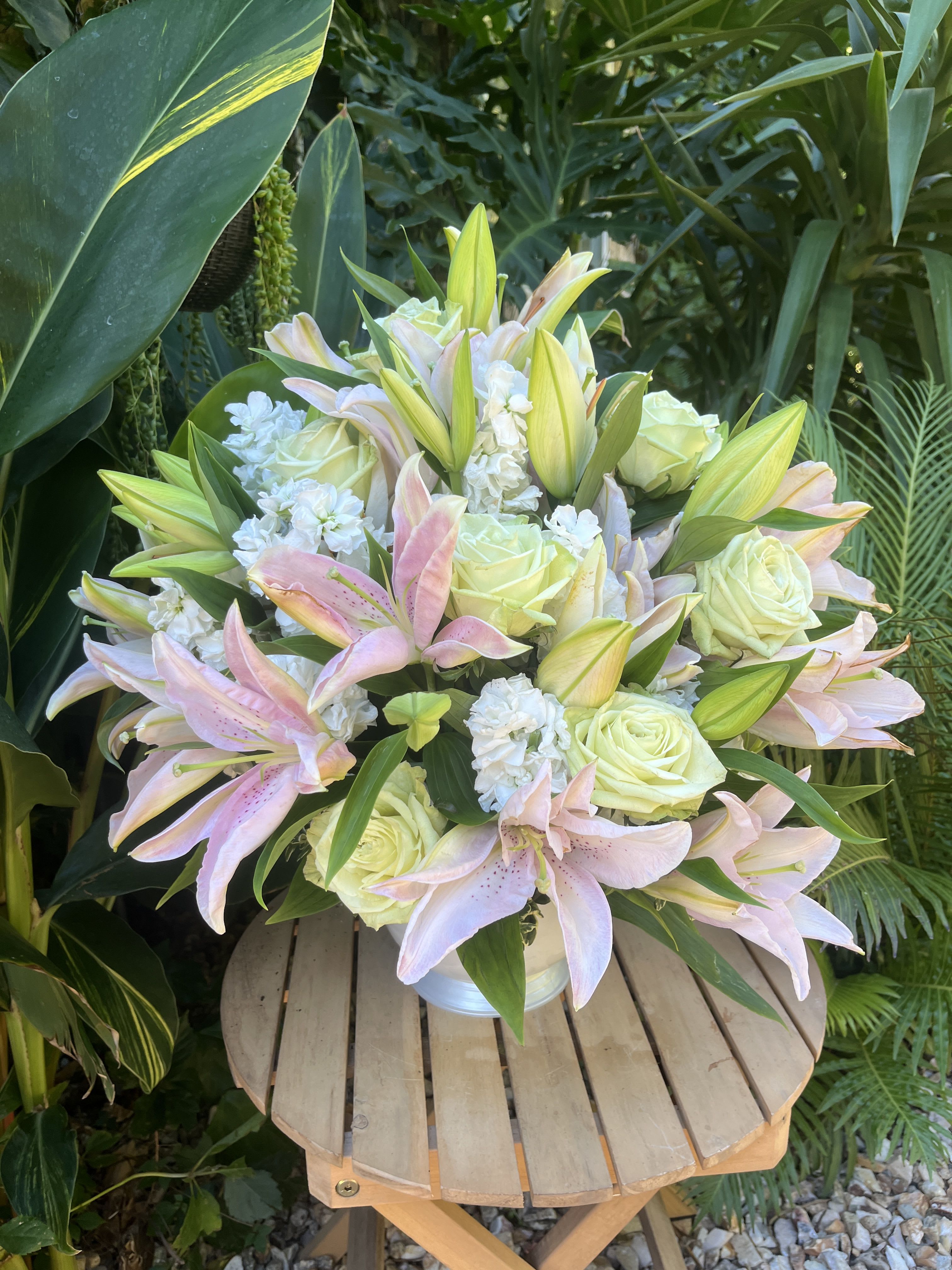 White Sympathy - Individually made and custom arrangements to express sympathy for loss of a loved one. This bouquet is primarily white using fresh, seasonal flowers with greenery. 