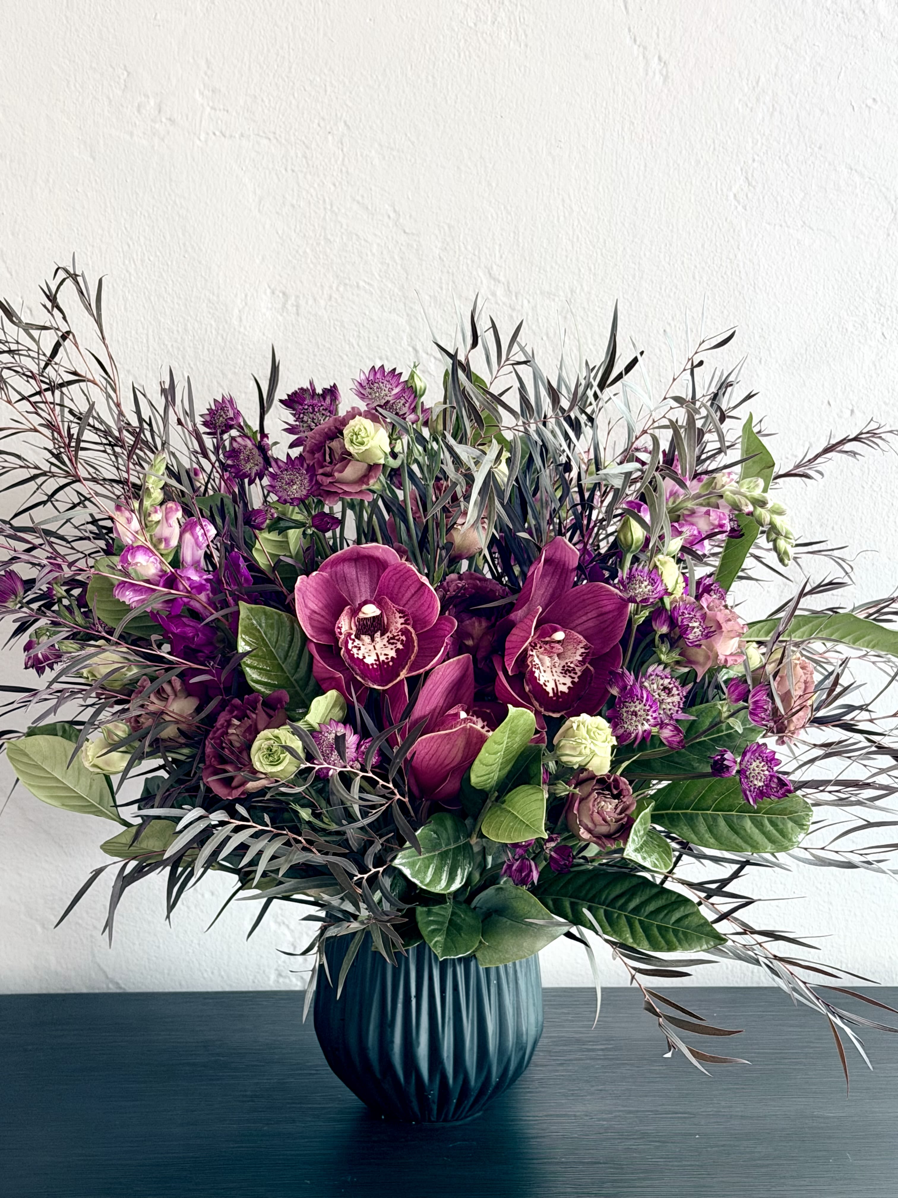 Oh My Goth! - Unique and dramatic arrangement features richly colored maroon blooms! 