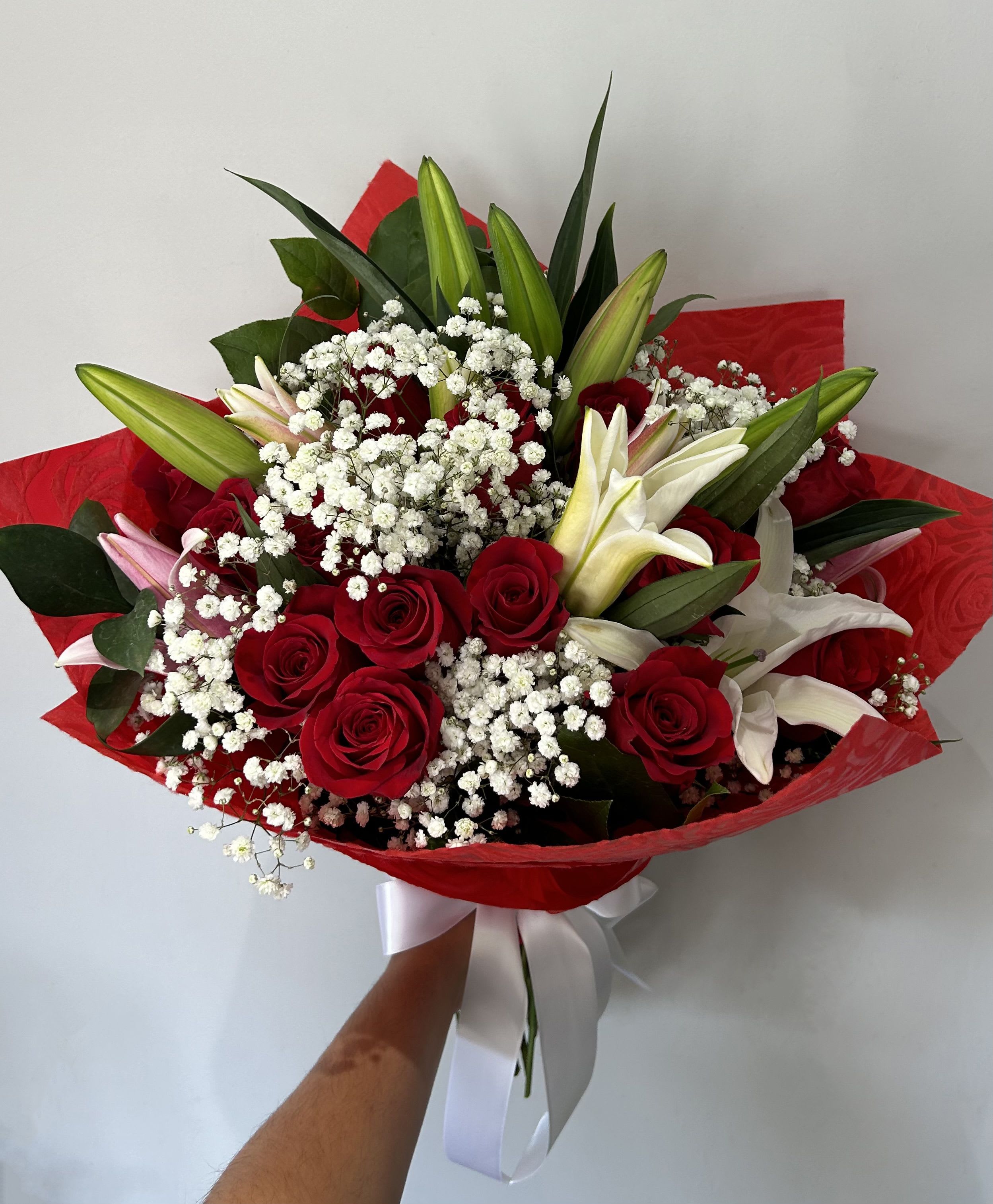 Lilies and Roses Bouquet - Lilies and red roses arranged with fillers and greens into a hand-tied bouquet.  NOT CAT-FRIENDLY FLOWERS