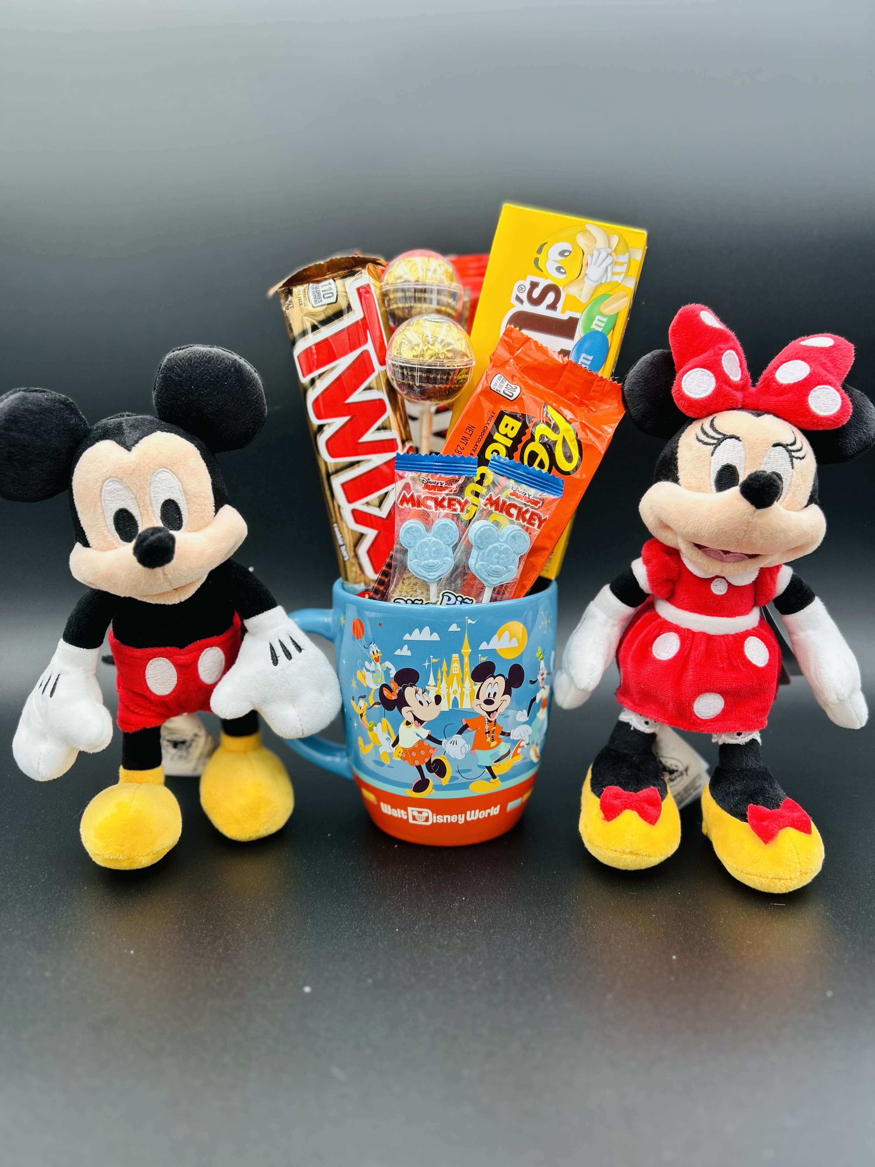 A Disney Mug 2 - Adorable gift arrangement, includes an original 8 1/4" Mickey Mouse &amp; Minnie with a retro mug accompanied by a variety of chocolates and candies.