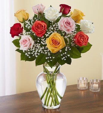 Dozen Mixed Roses - A floral arrangement featuring roses of multiple colors, combining sentiments like love, friendship, and purity in a single bouquet. Colorful and blooming, this vibrant bouquet of one dozen roses is an instant mood booster. An abundance of the freshest roses will delight everyone from your special someone to your best friend for any occasion or sentiment.  The colorful and varied look is often preferred for its visual appeal and is a great choice for someone who loves color and variety.