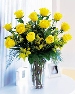 Dozen Yellow Roses - Our vibrant yellow roses will fill someone’s day with sunshine. These bright, cheerful blooms are a warm, thoughtful gift that will leave them beaming, whatever the occasion. The arrangement also includes filler flowers and greenery, such as solidago or baby's breath.