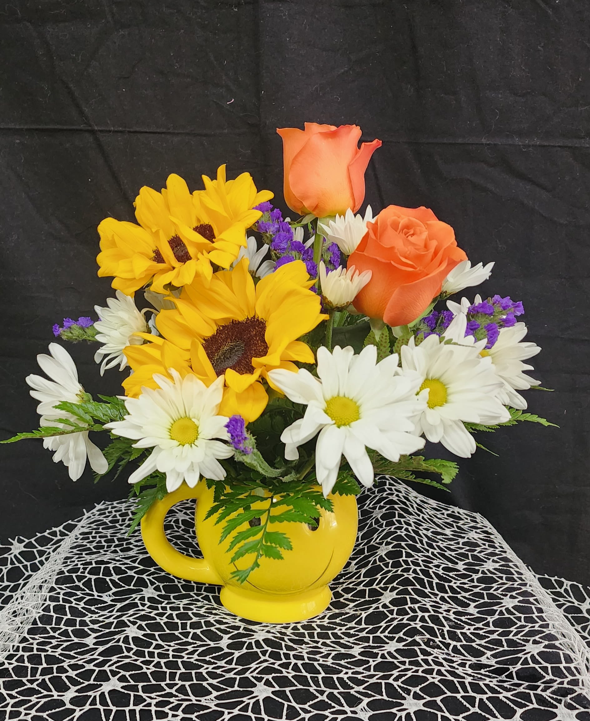 The Happy Little Hippy -  Sunflowers, roses and daisies with little pops of purple statice in this cute smiley mug is sure please that happy little hippy in everyone!