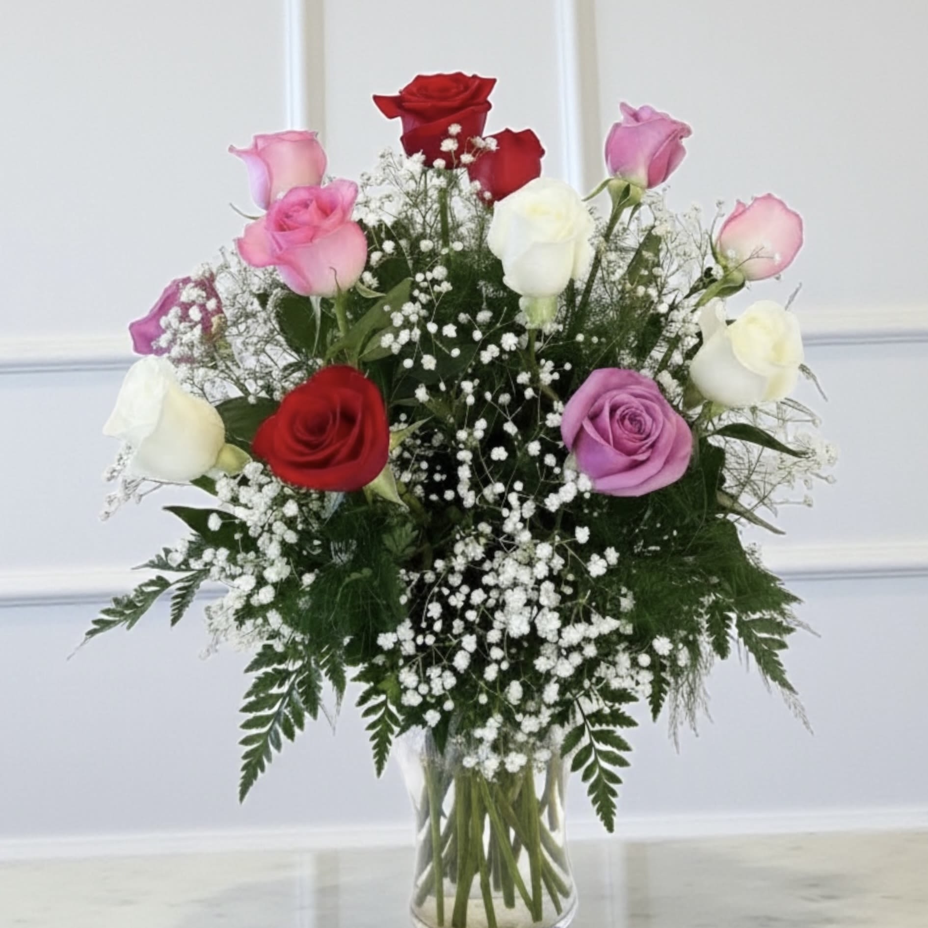 Mixed Color Roses - Can't decide on a rose color...get an assortment of rose colors with our Mixed Color Rose Bouquet. Bouquet includes a dozen red long stem, pink, white and lavender roses designed in a glass vase with greenery and baby's breath. Sizes include: Standard 12 roses, deluxe 18 roses and premium 24 roses
