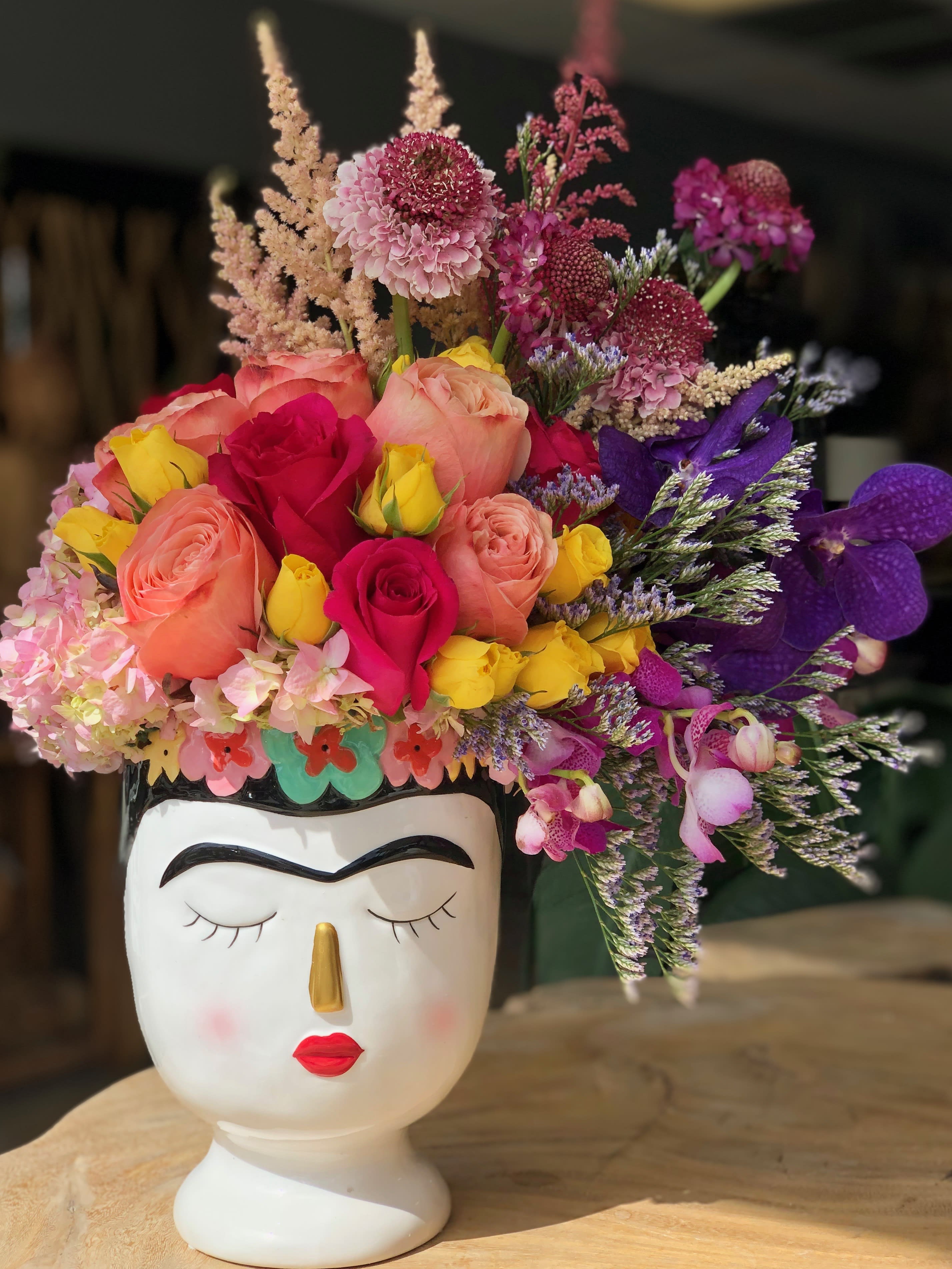 Frida - Frida, a perfect pop of color sure to brighten anyone's day. Frida is filled with the seasons premium blooms.