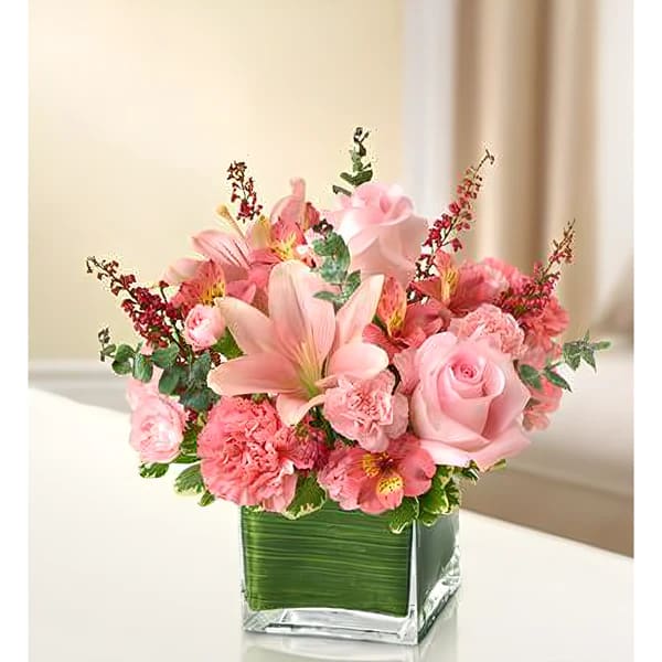 In my Thoughts - All Pink - Product ID: 95384  Let the vibrant beauty of our graceful all-pink bouquet convey your deepest sympathies. Help heal their spirit during times of loss with this cube vase arrangement of pink roses, lilies, alstroemeria, carnations and heather, ideal for the home or service. Elegant arrangement of fresh pink roses, lilies, alstroemeria, carnations, mini carnations and heather, accented with variegated pittosporum and spiral eucalyptus Artistically designed by our florists in a classic clear glass cube vase lined with a Ti leaf ribbon; vase measures 5"H x 5"D Appropriate for the service or for sending to the home or office of friends and family members Large arrangement measures approximately 11"H x 11"L Medium arrangement measures approximately 10"H x 10"L Small arrangement measures approximately 9"H x 9"L Our florists hand-design each arrangement, so colors, varieties, and container may vary due to local availability Lilies may arrive in bud form and will open to full beauty over the next 2-3 days
