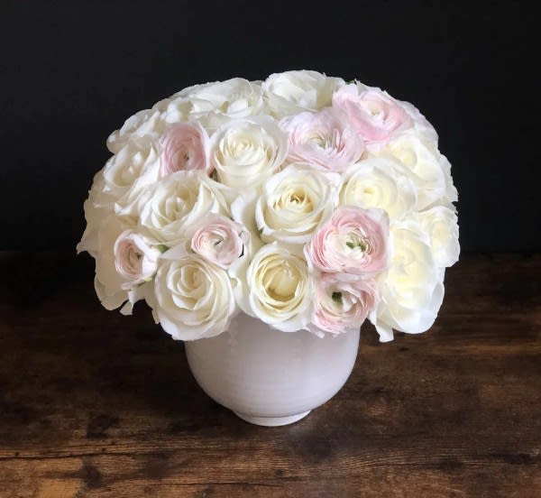Femininity - If anything expresses femininity, it is the colors pink and white.  We've mixed pink and white roses cut extra short and placed tight and compact in a low cylinder.  It will make her smile!