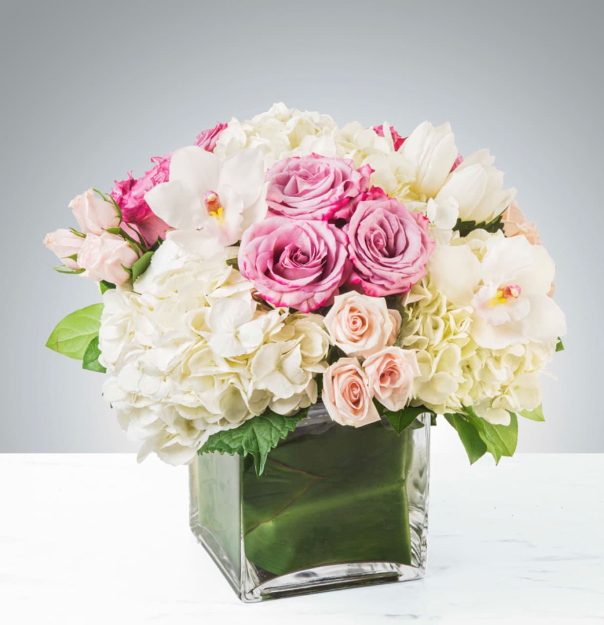 Carolina - Classic and Beautiful, this large arrangement whispers luxury. Soft pinks, whites and creams come together to create an appealing array of fresh flowers.   APPROXIMATE DIMENSIONS: 15" W X 15" H    