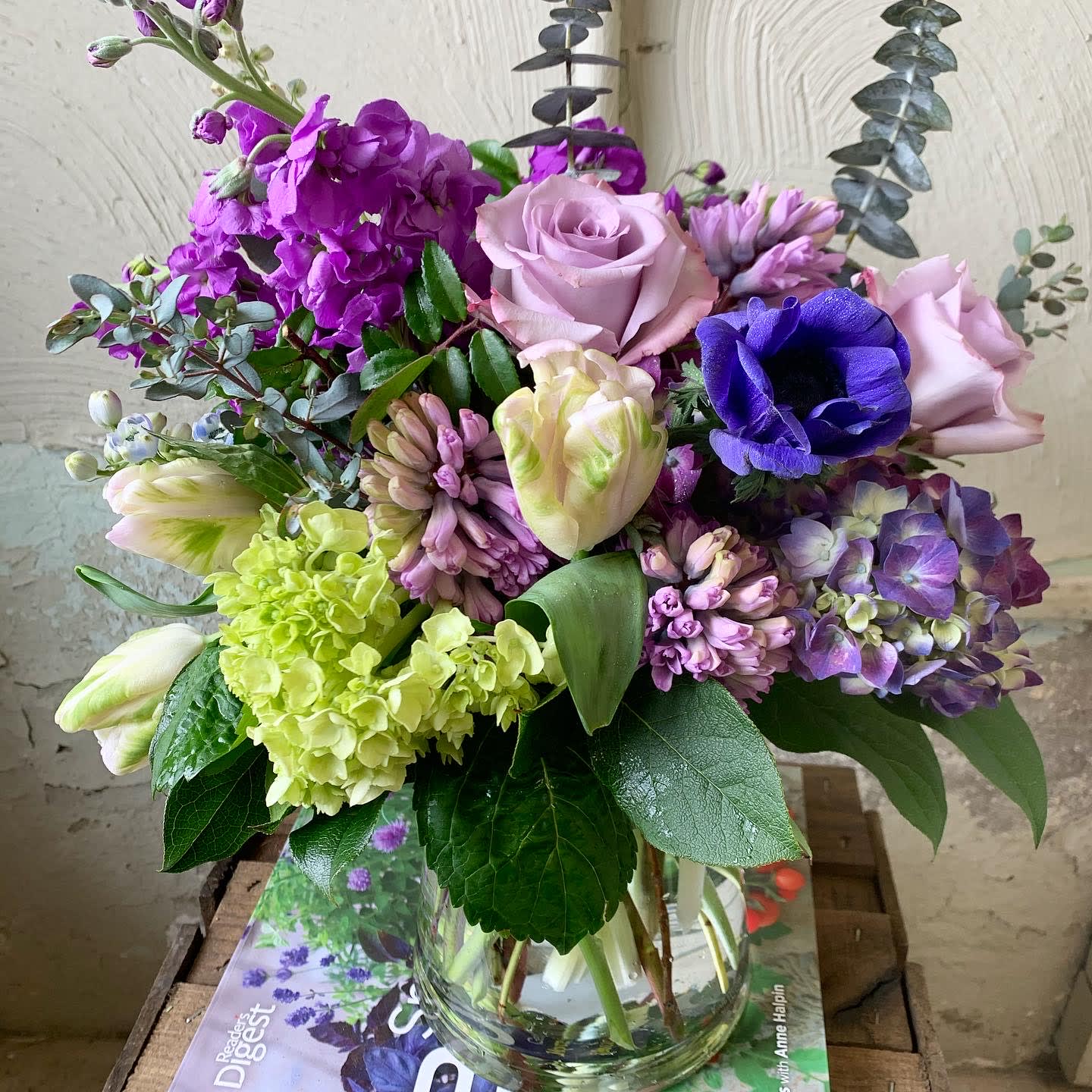 Purple Rain - An array of spring florals in soft purple tones. Hyacinths, tulips, hydrangeas, stock, anemones and roses with eucalyptus accents.