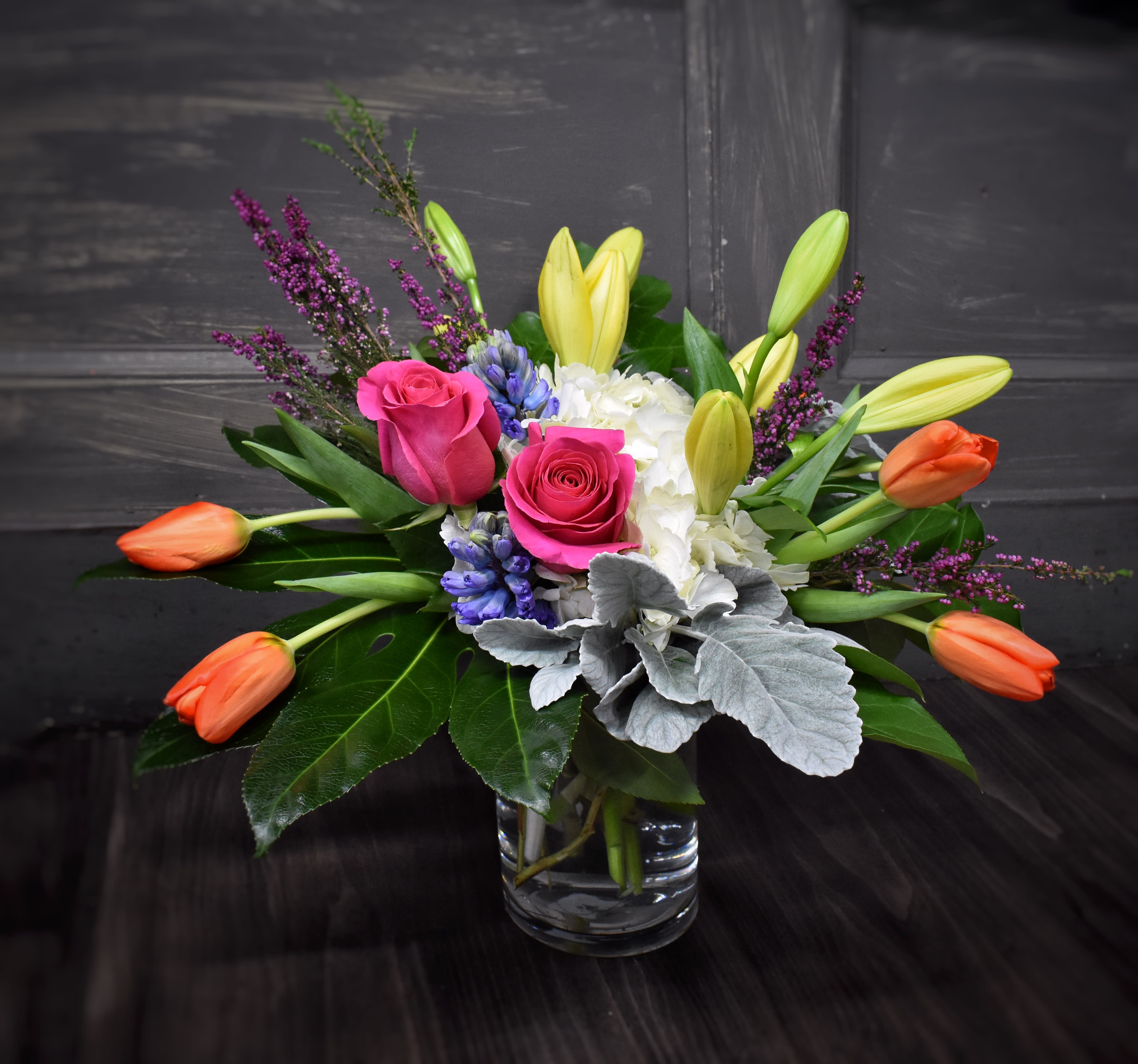 Colorful Sensation - A clear glass vase is filled with the sights and smells of spring! Lilies, tulips, fragrant hyacinths, roses and hydrangea complete this lovely spring bouquet.