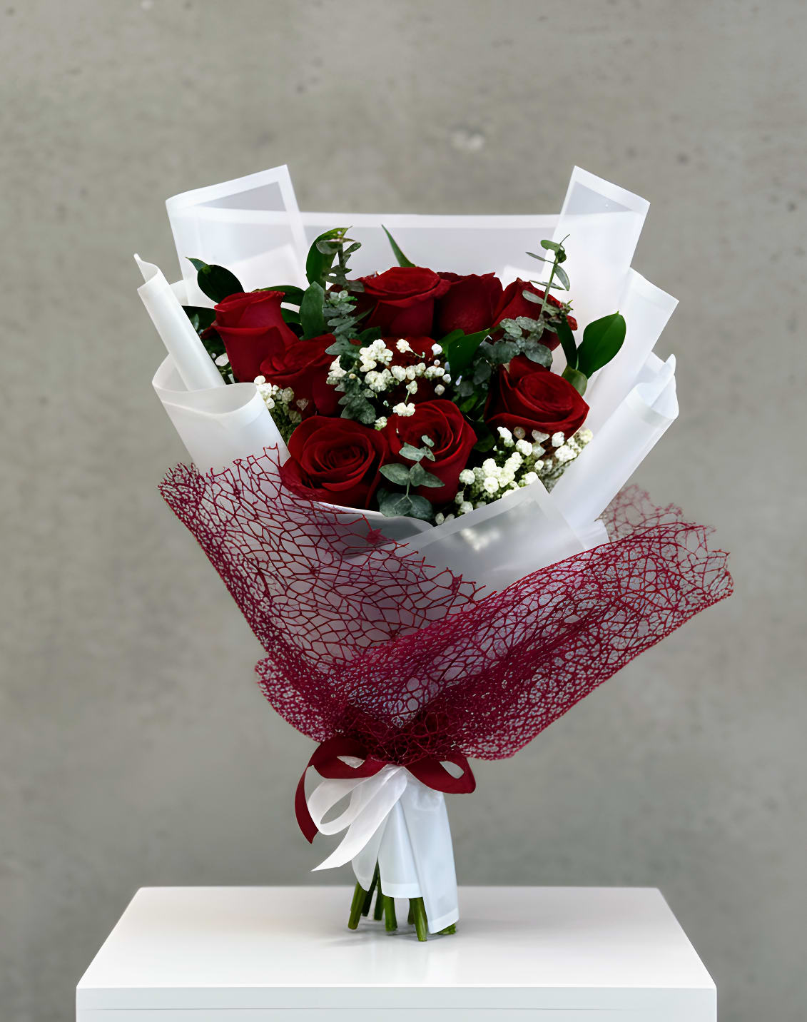 Amore di Rose - A romantic bouquet of red roses accented with soft filler flowers and greenery, designed to express love and appreciation.  Available in 12 roses for standard or 24 roses for premium.