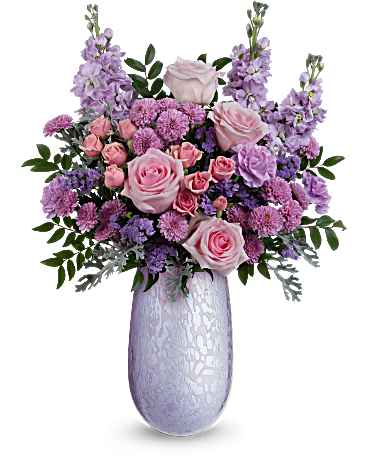 Teleflora's Joyful Blossoms Bouquet - What a treat! Overflowing with pink roses and lavender blooms, this stunning Mother's Day bouquet is artfully arranged in Teleflora's hand-blown iridescent glass Vivi vase-a keepsake Mom will treasure.