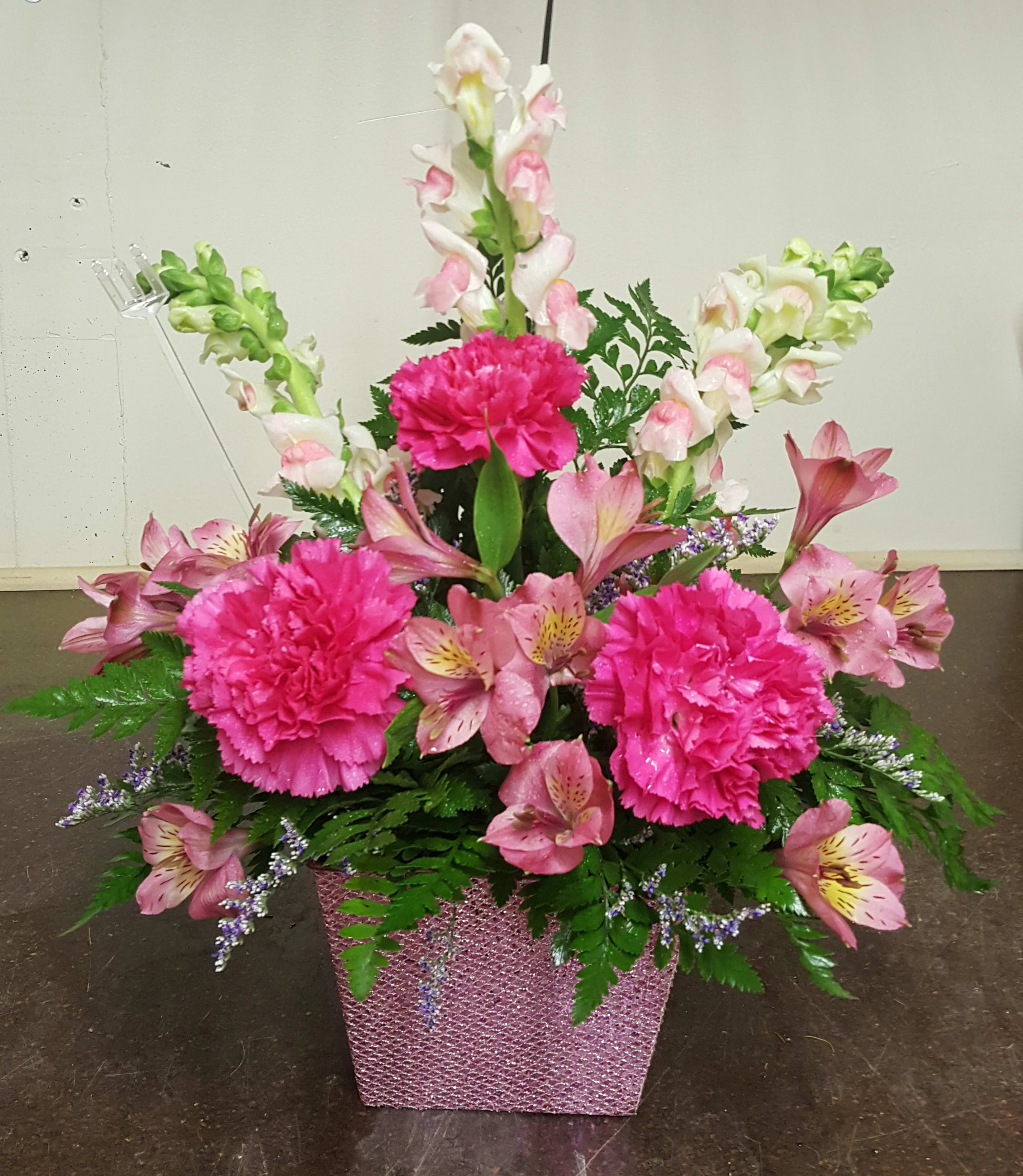 Pink Dreams - Shades of pink snapdragons, carnations and Alstro in a pink container (there may be container substitutions depending on inventory)
