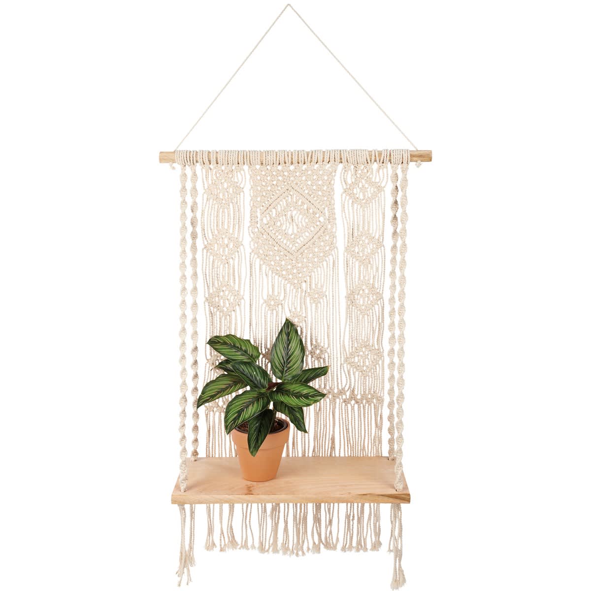 Macramé Shelf - A wooden shelf featuring a cotton macramé designed backdrop leading to shelf supported by macramé cords with long tassels underneath. Pot and plant pictured not included. Our Macramé shelf is easy to display via attached cotton hanger. A neutral everyday home accent with a variety of display options.