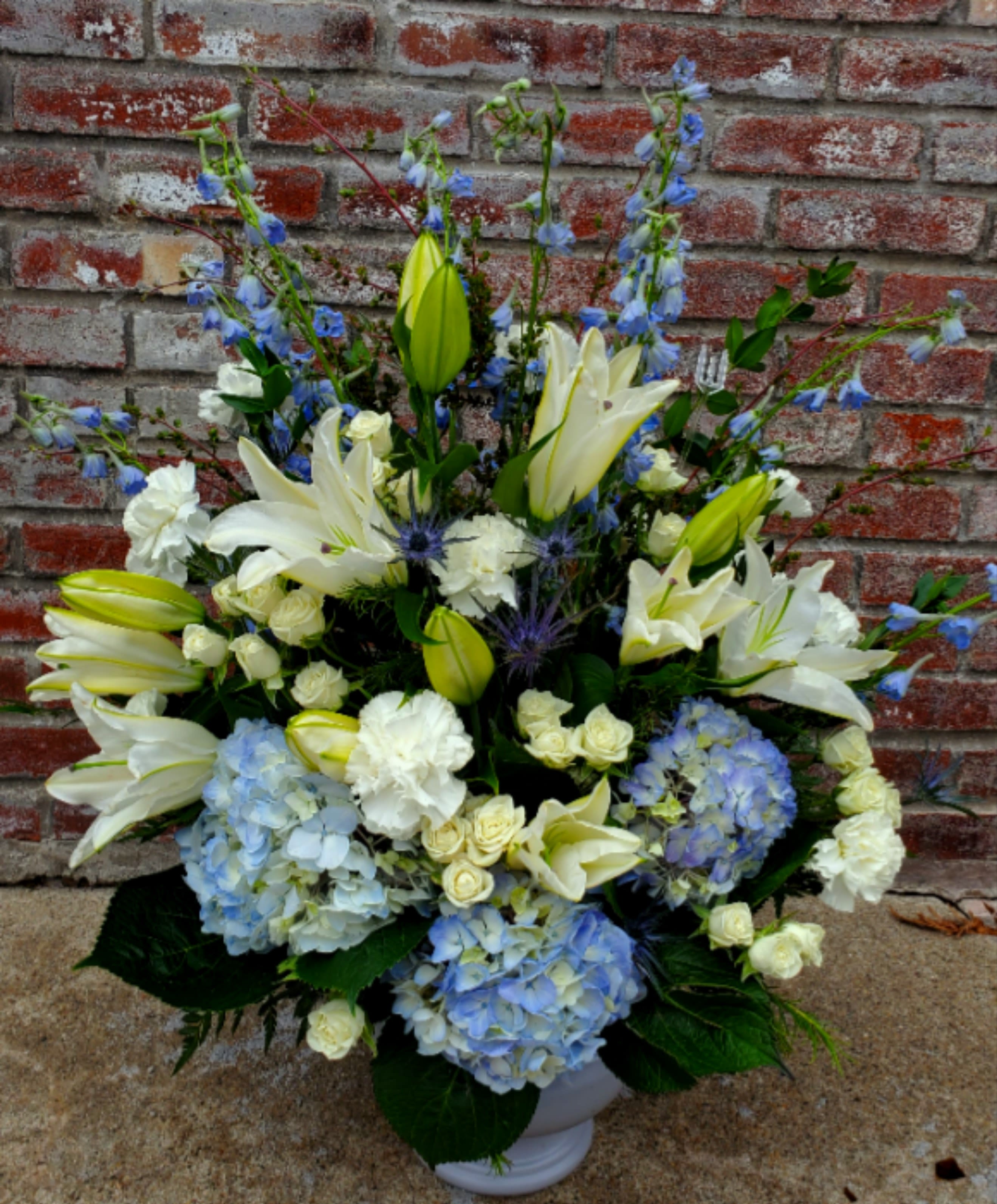 Blue Sky - White lily, blue hydrangea mix makes a perfect sympathy piece for your loved one.