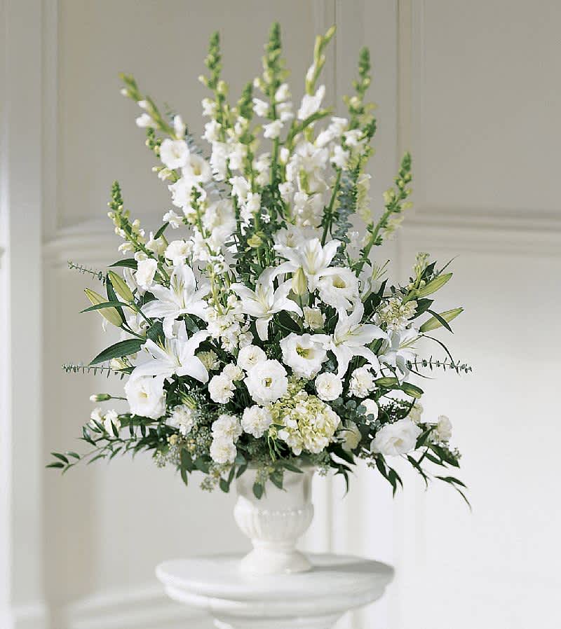 Serenity - A classic design that can be easily customized to your color preference. The Serenity Urn features seasonal flowers and mixed greenery. The large urn arrangements are typically purchased in matching pairs and displayed on each side of the casket for a funeral service. Due to the current situation, supply is limited, therefore, color and variety substitutions of flowers or container may be necessary, please specify if you have a preference and we will do our best to accommodate your request.