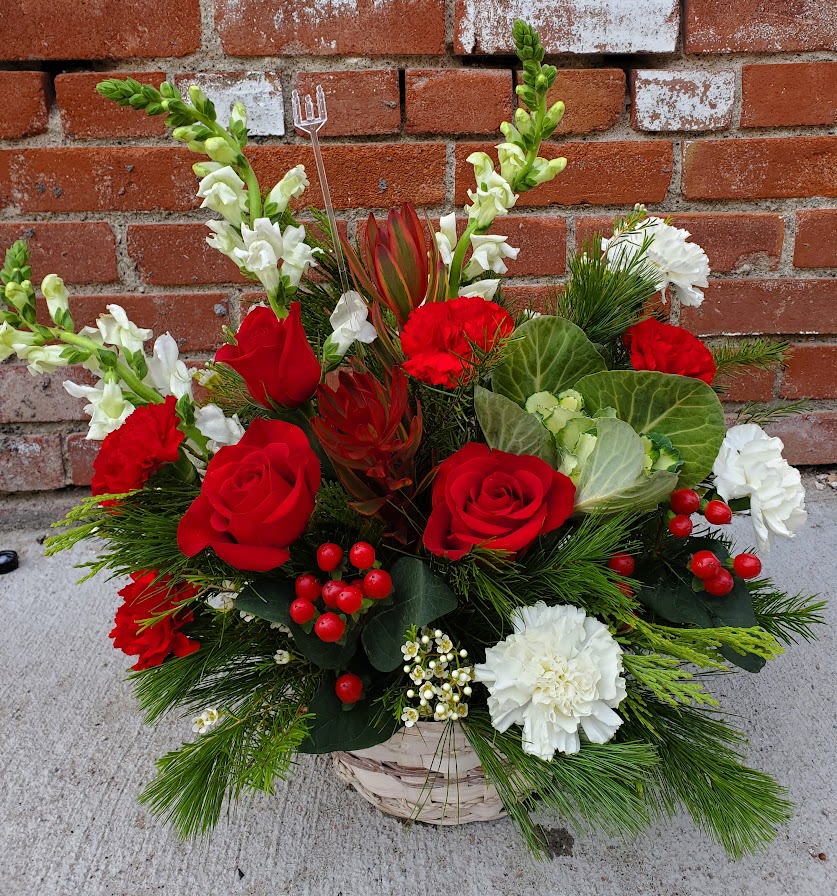 Christmas delight - White basket of winter greens with roses, berries and carnations