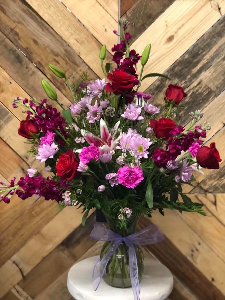 Love in Bloom - This Love in Bloom bouquet is the perfect arrangement for any occasion. Premium roses with tall stock and lilies, adorned by other bright fillers. This is perfectly arranged by our floral team just for you!